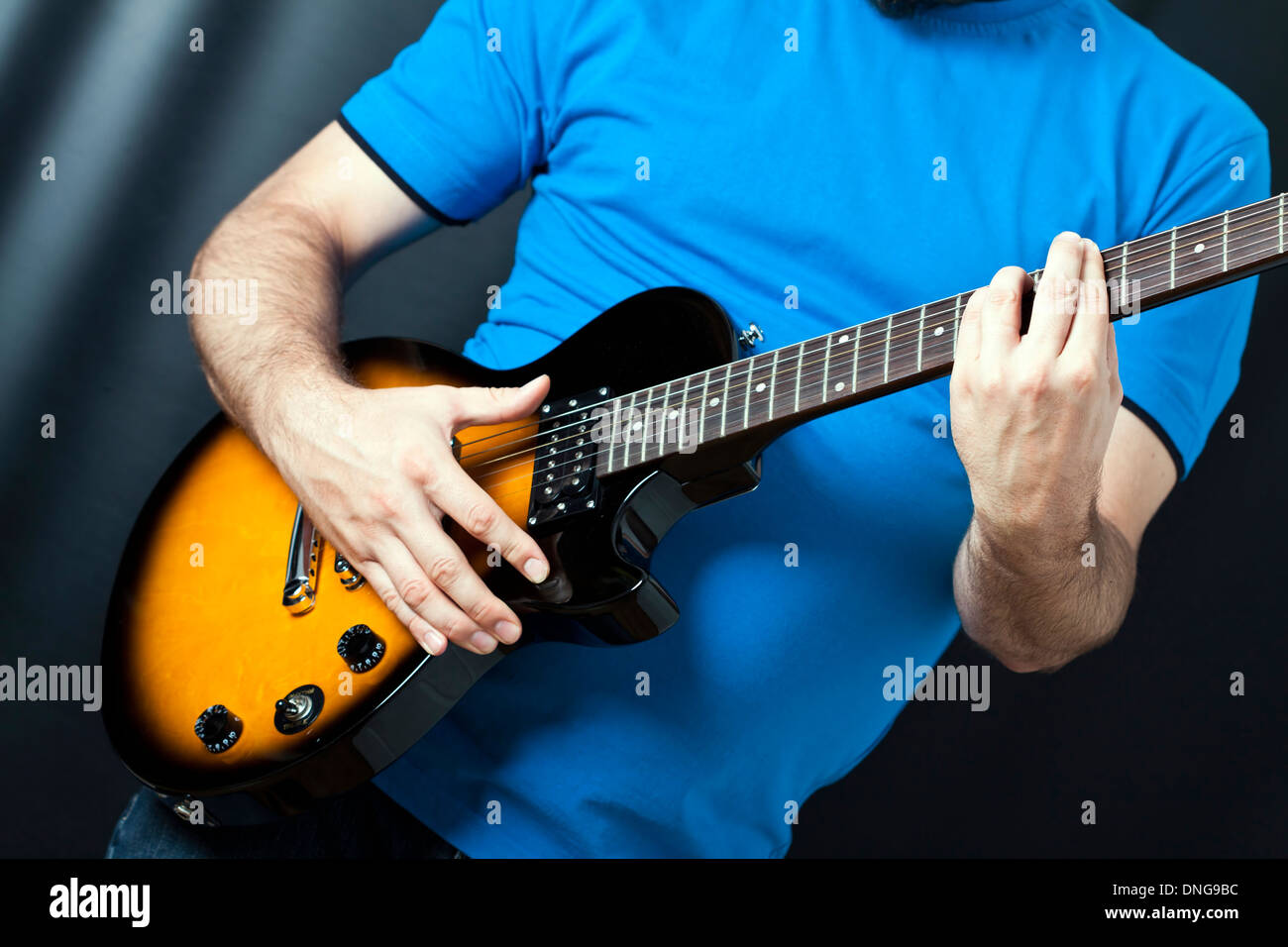 Guitarist playing on electric guitar Stock Photo - Alamy