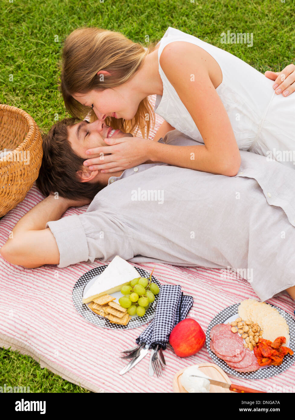 Attractive couple kissing on romantic afternoon picnic in countryside Stock Photo