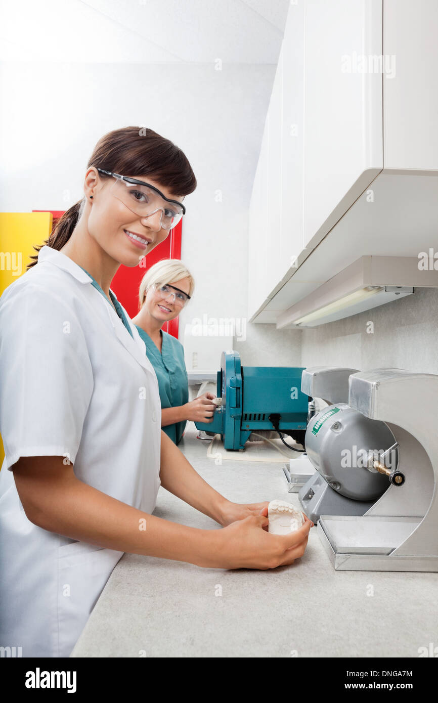 Dentist Holding Dental Plaster Mold With Assistant At Clinic Stock Photo Alamy