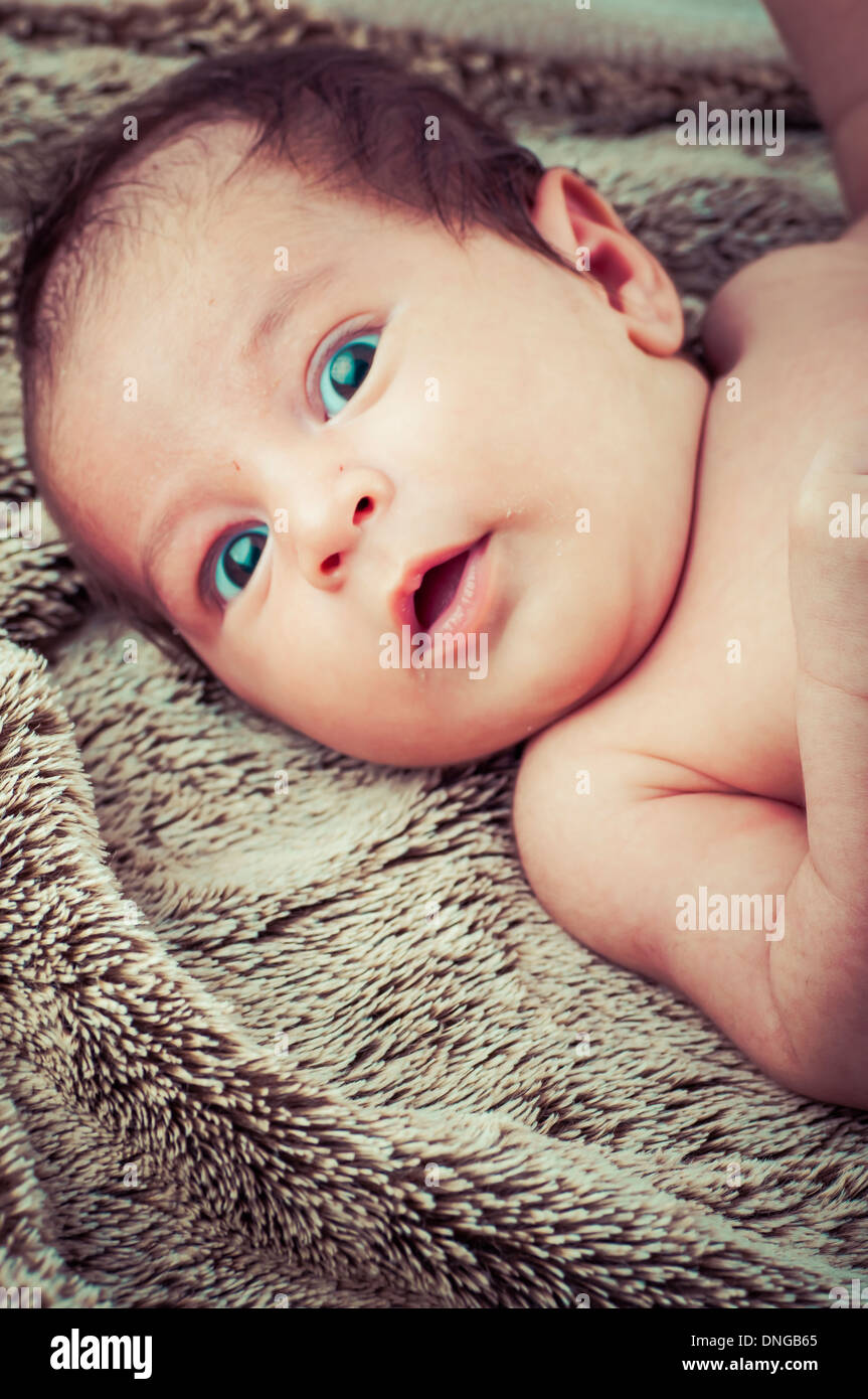 Newborn peacefully sleeping, picture of a baby curled up sleeping on a