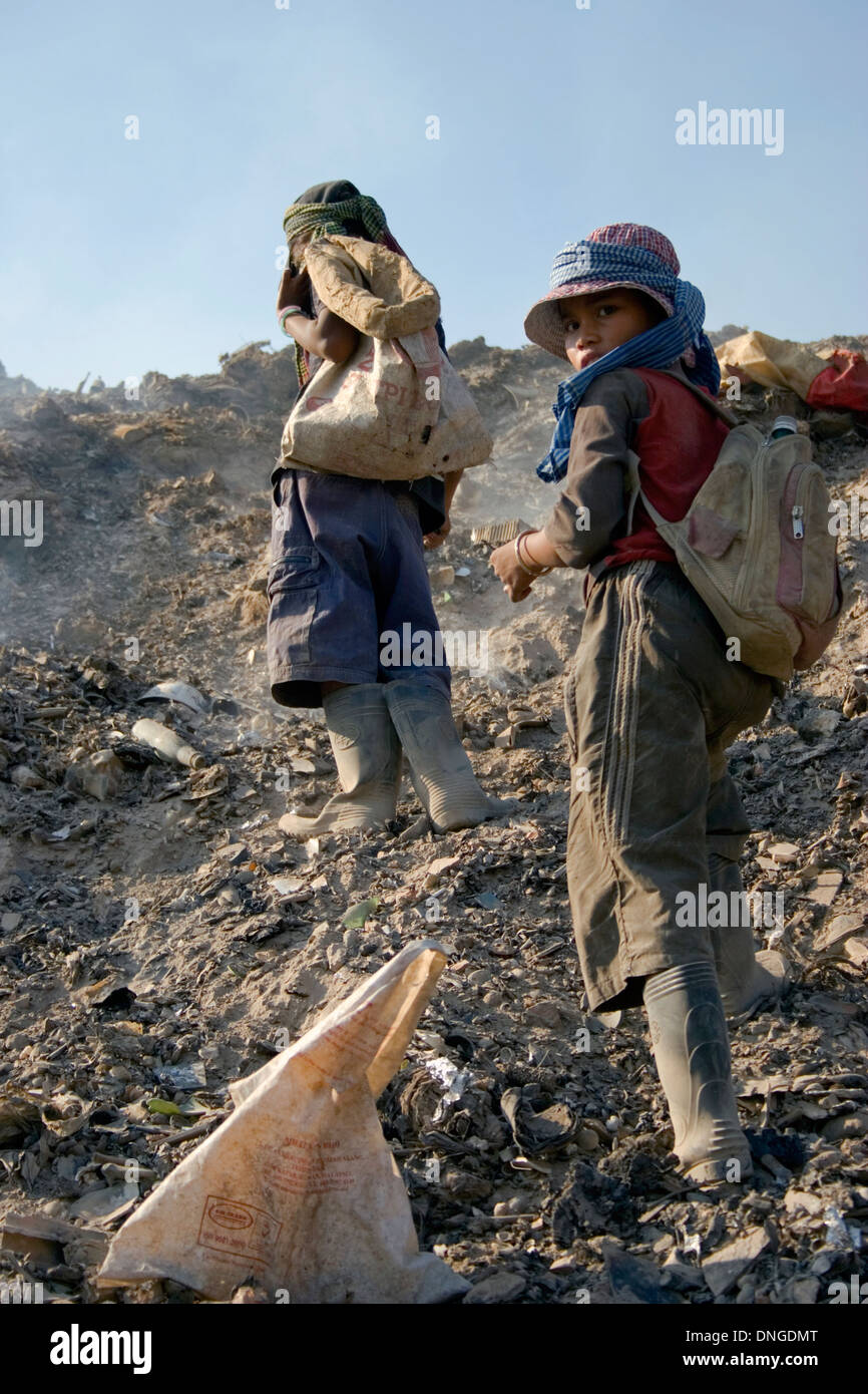 Two young child laborer girls are collecting recyclable material at the toxic Stung Meanchey Landfill in Phnom Penh, Cambodia. Stock Photo