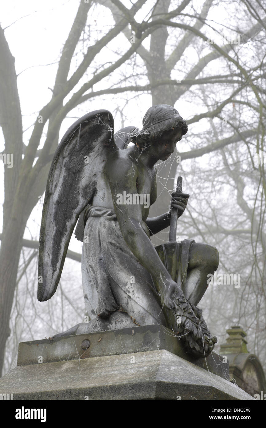 old abandoned grave with the statue of a angel Stock Photo