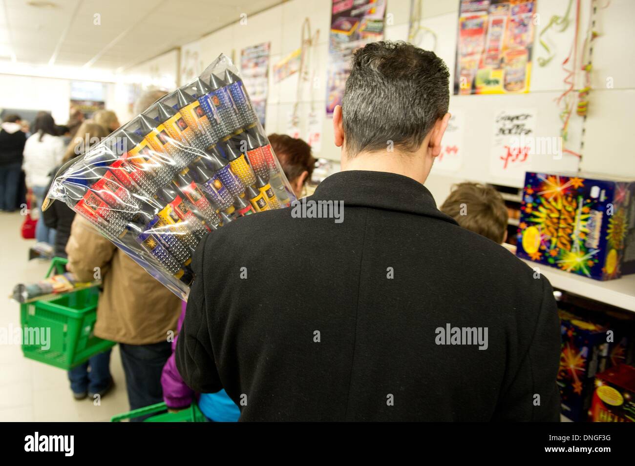 Dresden, Germany. 28th Dec, 2013. A Costumers holds a bag of firecrackers in Dresden, Germany, 28 December 2013. The selling of New Year rockets and fireworks has officially begun on 28 December 2013. Photo: SEBASTIAN KAHNERT/dpa/Alamy Live News Stock Photo