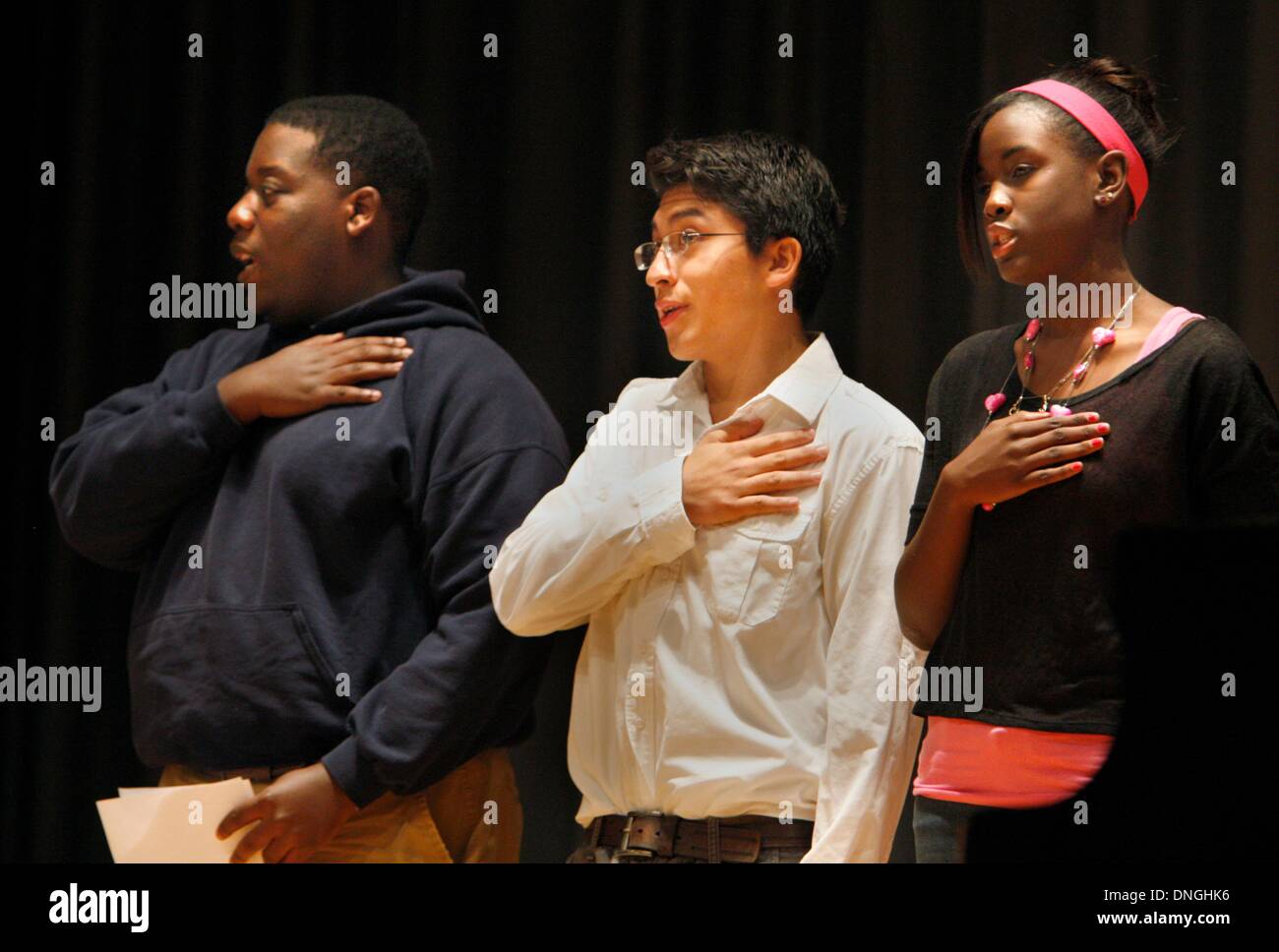Memphis, Tennessee, USA. 26th Oct, 2012. October 26, 2012 - Isaias Ramos (center) recites the pledge of allegiance during a school program where he performed, playing piano. He was brought to America illegally at the age of eight from Mexico. In the last ten years he has learned to speak English fluently, and he has risen to the top of his class. He is not an American citizen, but he holds a work permit, social security card, and a temporary driver's license. He has qualified for a new legalization program for hispanics that were brought to America, as children. (Credit Image: © Karen Pu Stock Photo