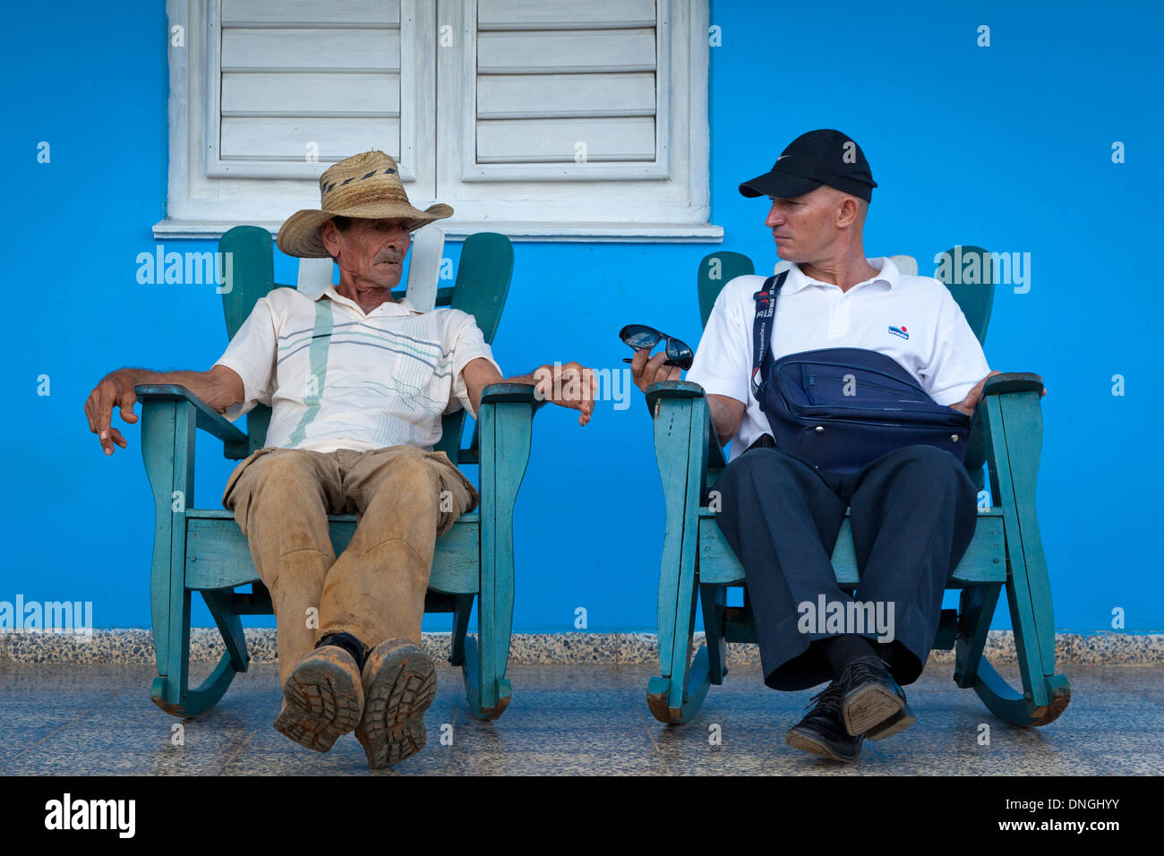 Two man talking in front of house in Cuba Stock Photo