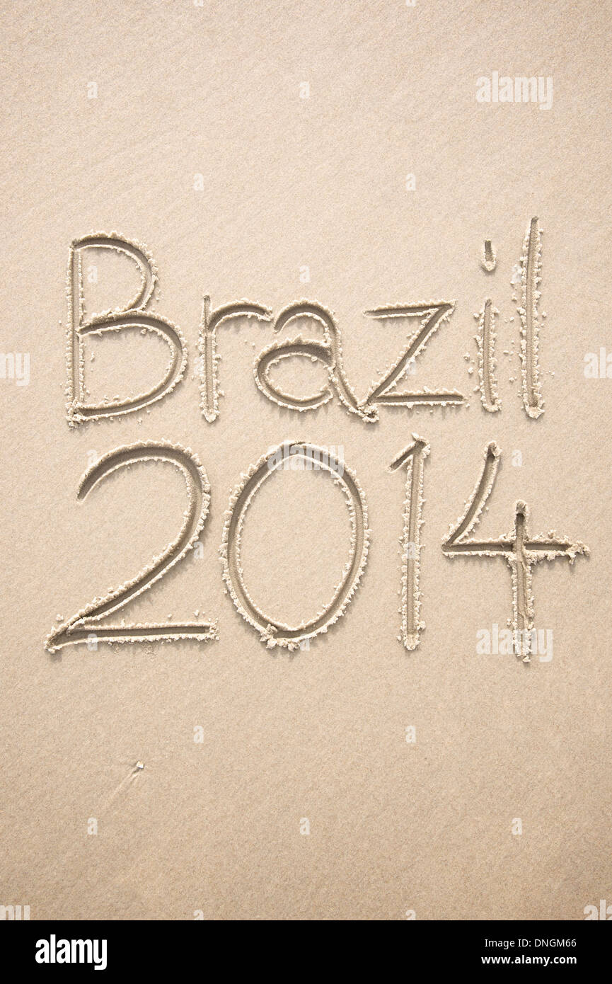 Brazil 2014 handwritten message on smooth Brazilian sand beach Stock Photo