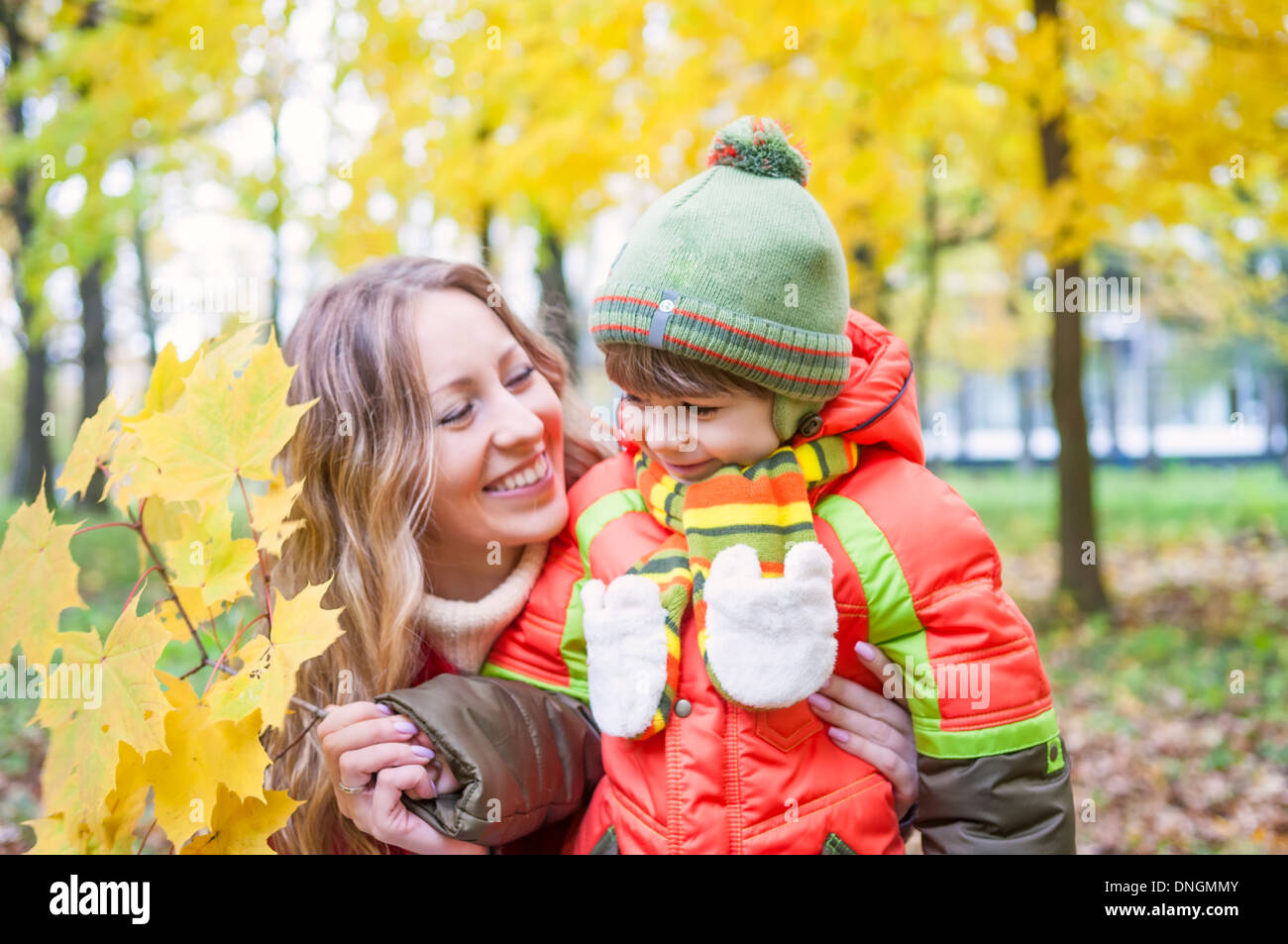Happy family in autumn park Stock Photo - Alamy