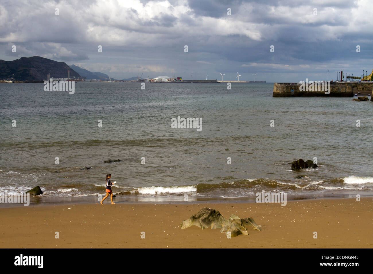 Getxo, beach woman running shoreline Biscay province. Vizcaya, Basque Country. Spain. Cantabrian sea. Stock Photo