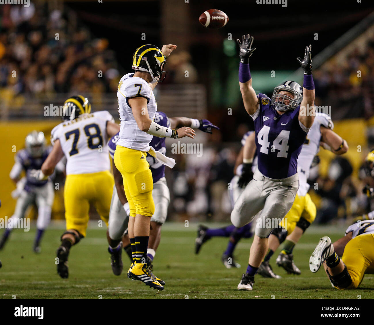 Tempe, Arizona, USA. 28th Dec, 2013. December 28, 2103: Michigan Wolverines quarterback Shane Morris (7) throws a pass with Kansas State Wildcats defensive end Ryan Mueller (44) applying pressure during the Buffalo Wild Wings Bowl NCAA football game between the Michigan Wolverines and the Kansas State Wildcats at Sun Devil Stadium in Tempe, AZ. Credit:  csm/Alamy Live News Stock Photo