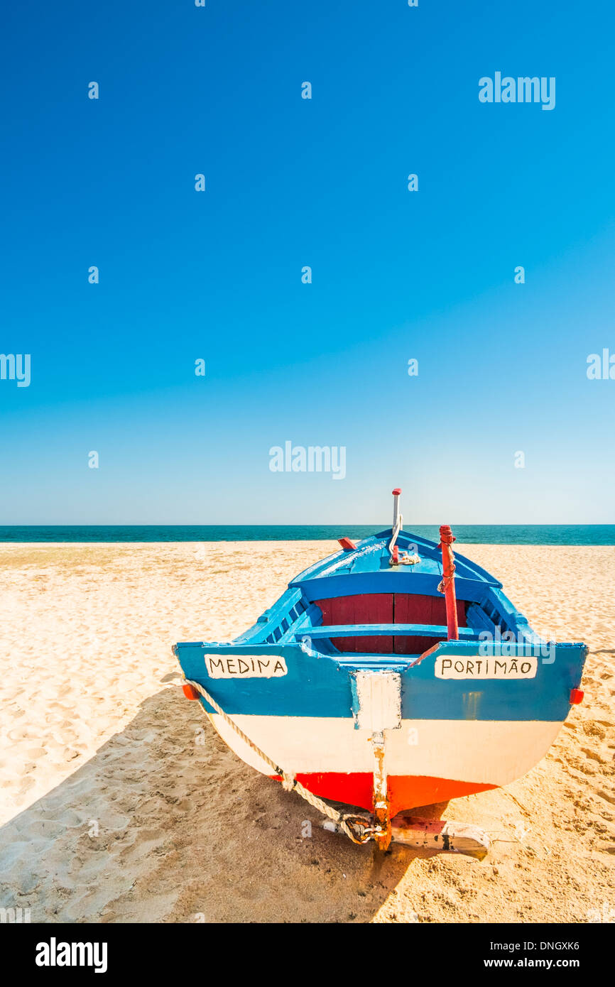 traditionally painted fishing boat on the beach of armacao de pera , algarve, portugal Stock Photo