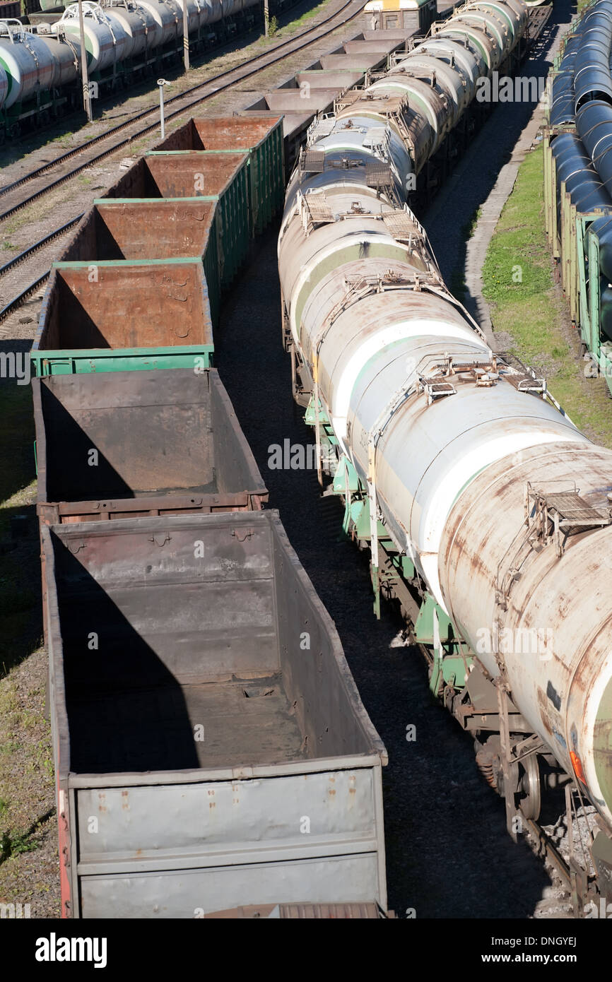 two freight trains with fuel cisterns and empty waggons Stock Photo