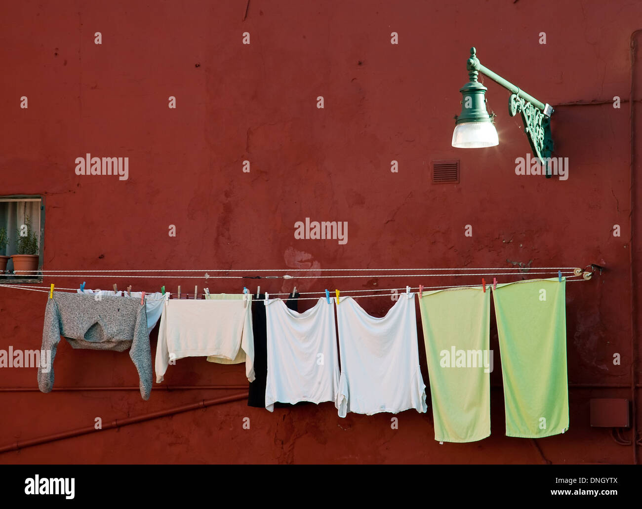 washing clothes on the rope closeup on the wall background Stock Photo