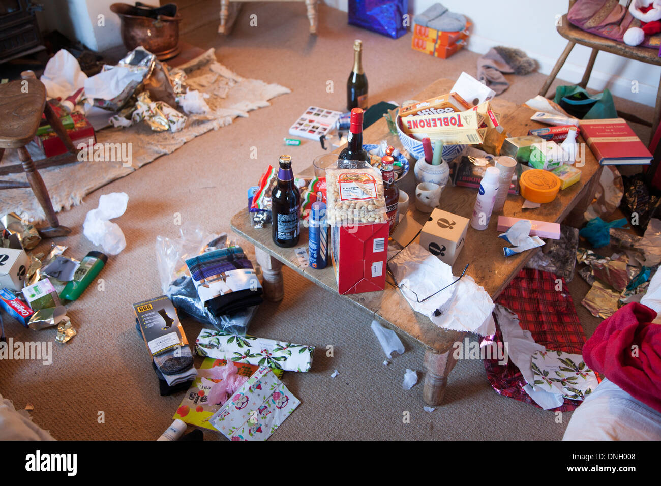 Mess of Christmas presents and wrapping paper scattered around a home, UK Stock Photo