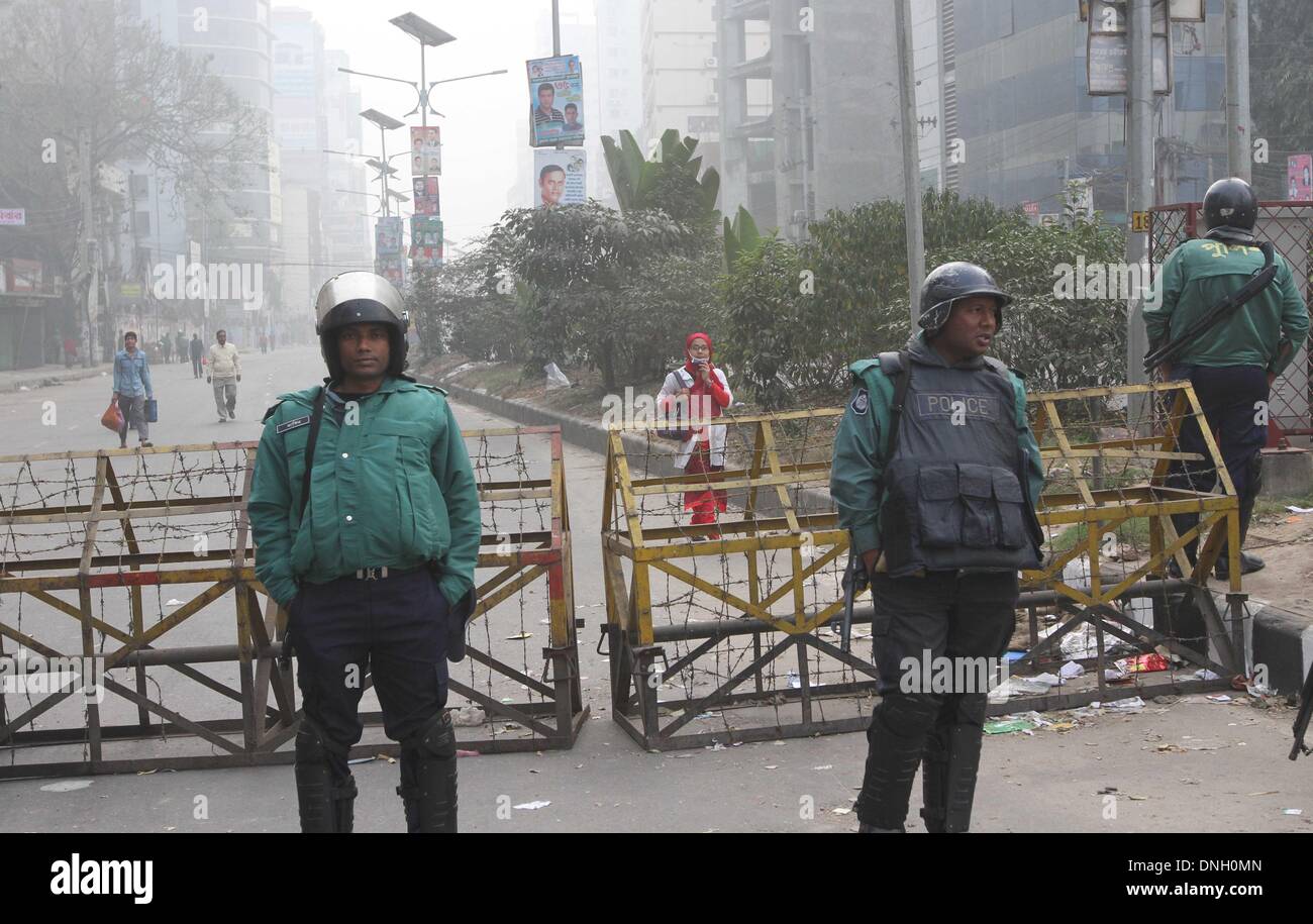 Dhaka, Bangladesh. 29th Dec, 2013. Bangladeshi police stand guard in front of the office of the main opposition Bangladesh Nationalist Party (BNP) in Dhaka on December 29, 2013. Opposition leader Khaleda Zia has said that the government is illegal, undemocratic and should step down immediately. Stock Photo