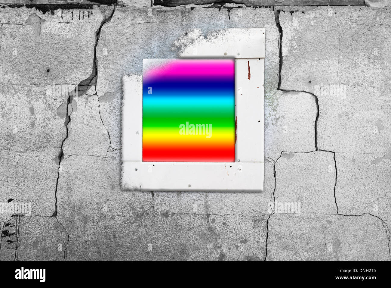 Old cracked wall with a window painted in rainbow Stock Photo