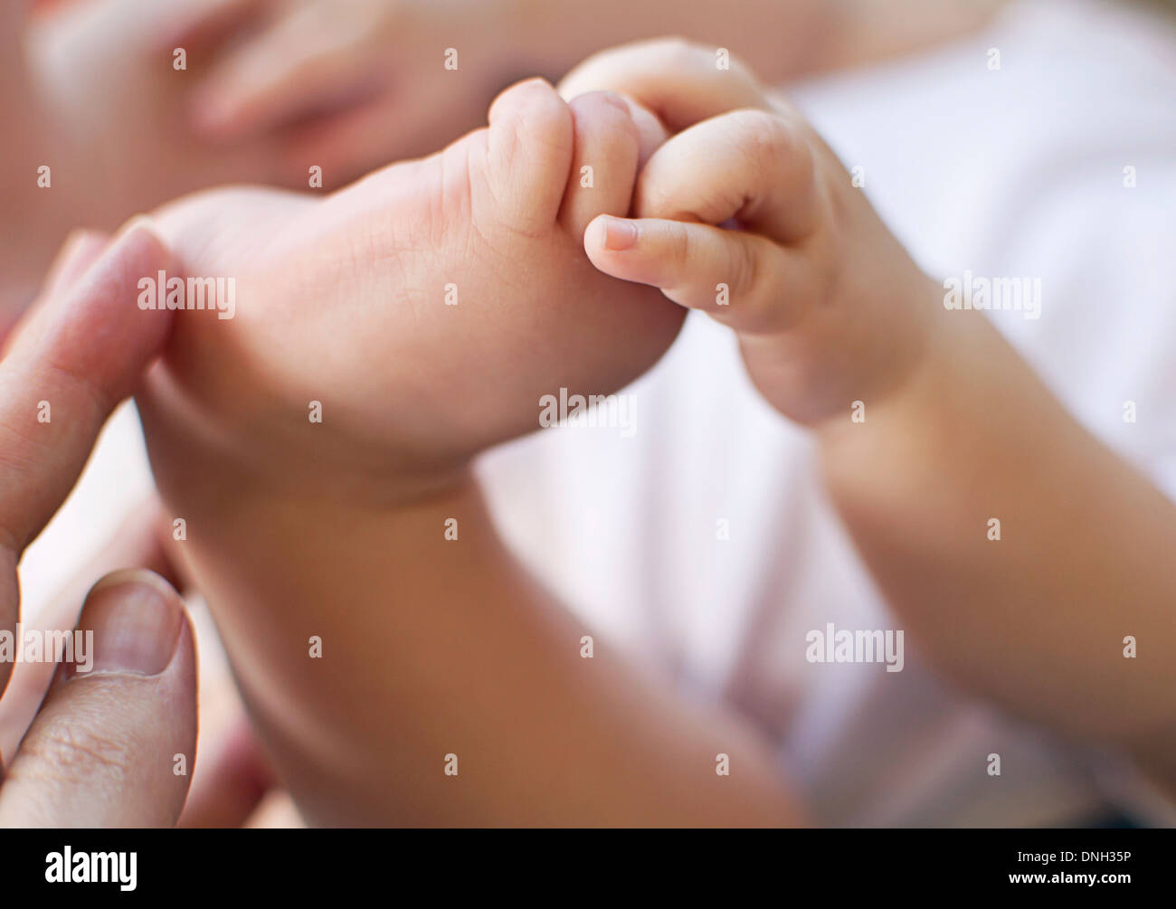 Baby Foot in Hands Stock Photo