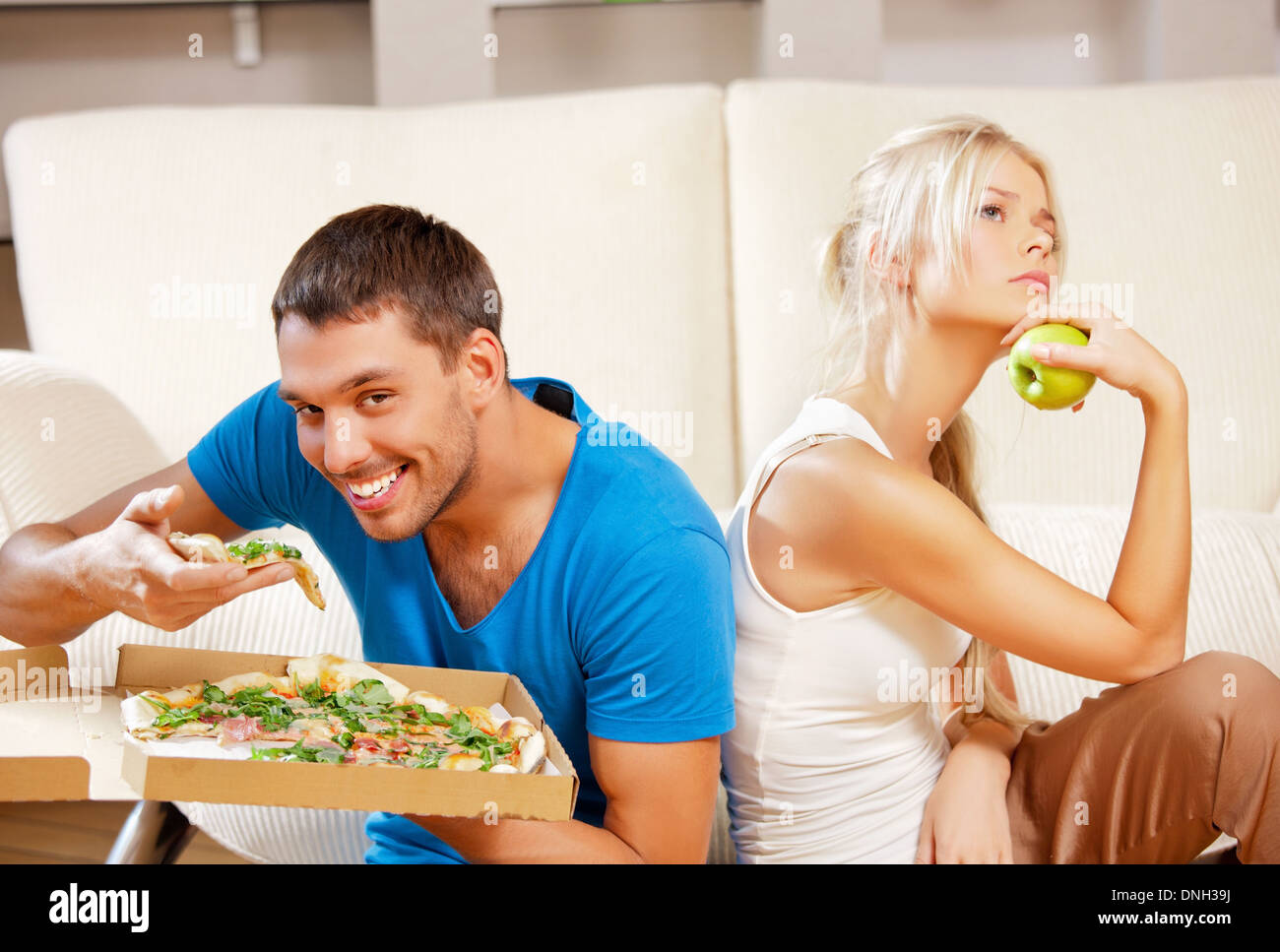 couple eating different food Stock Photo