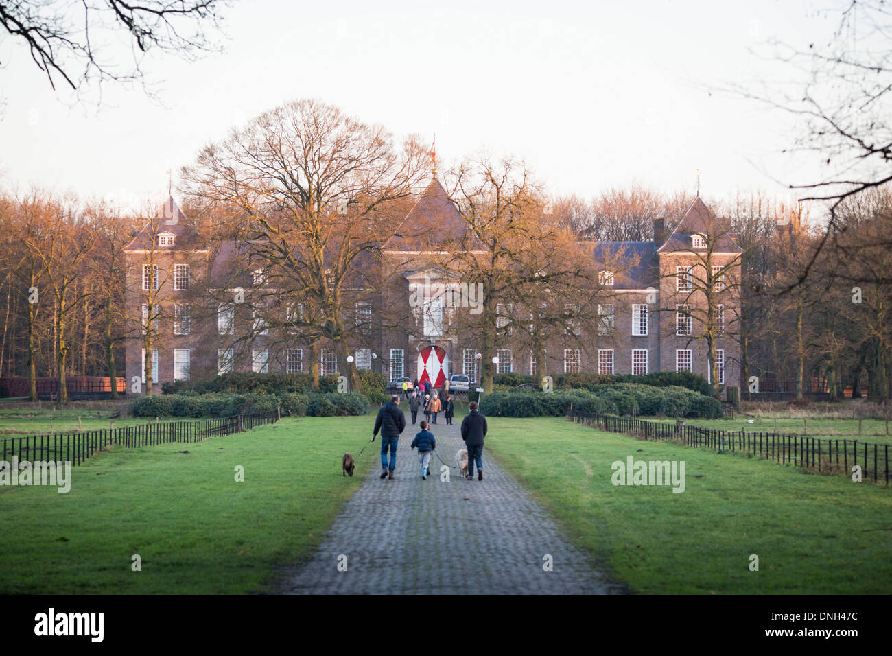 People walking towards the castle of Heeze during winter in the Netherlands Stock Photo