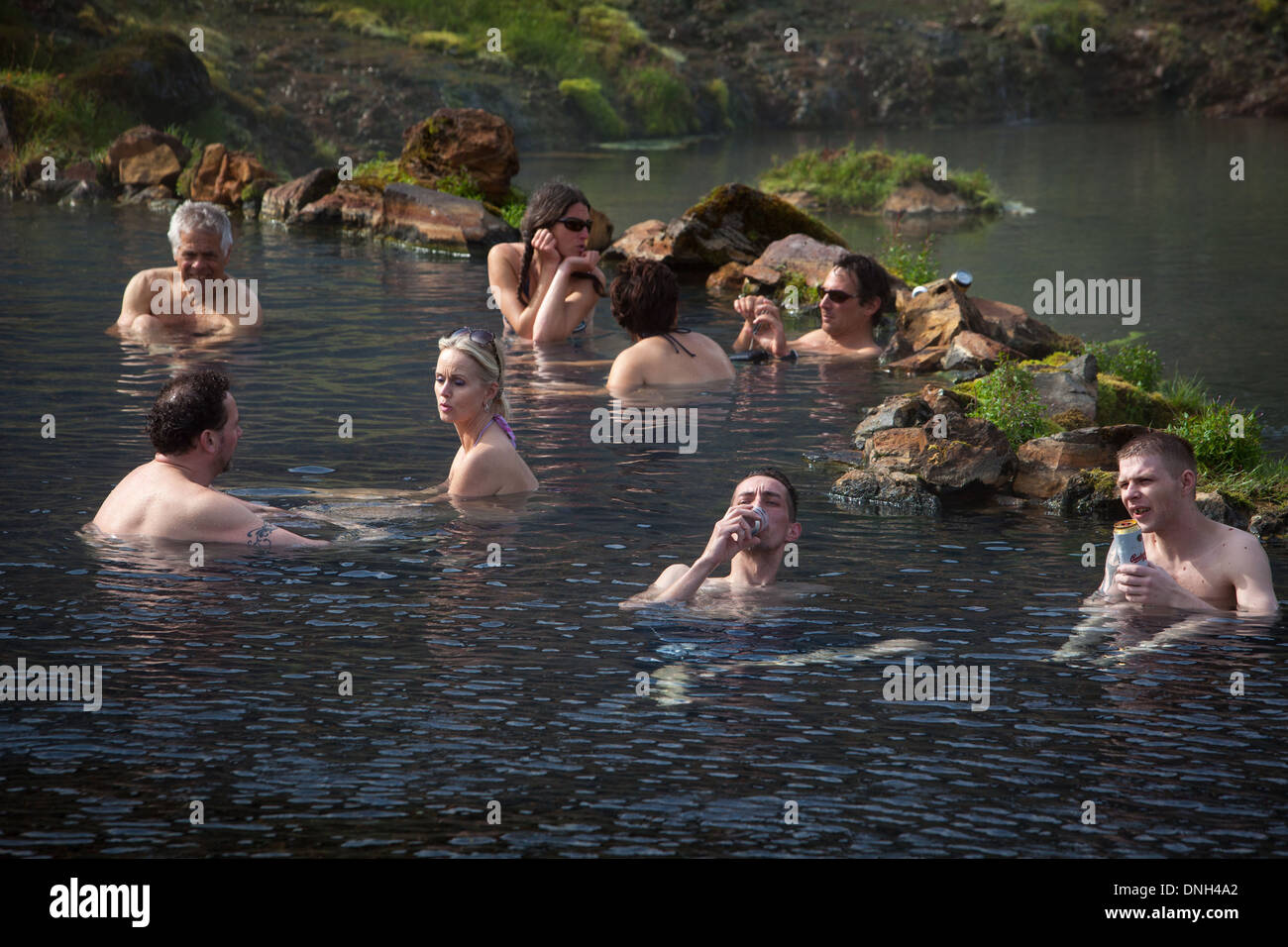 BATHING IN A NATURAL HOT SPRING, VOLCANIC AND GEOTHERMAL ZONE OF LANDMANNALAUGAR, THE NAME LITERALLY MEANS 'HOT BATHS OF THE PEOPLE OF THE LAND', REGION OF THE HIGH PLATEAUS, SOUTHERN ICELAND, EUROPE Stock Photo