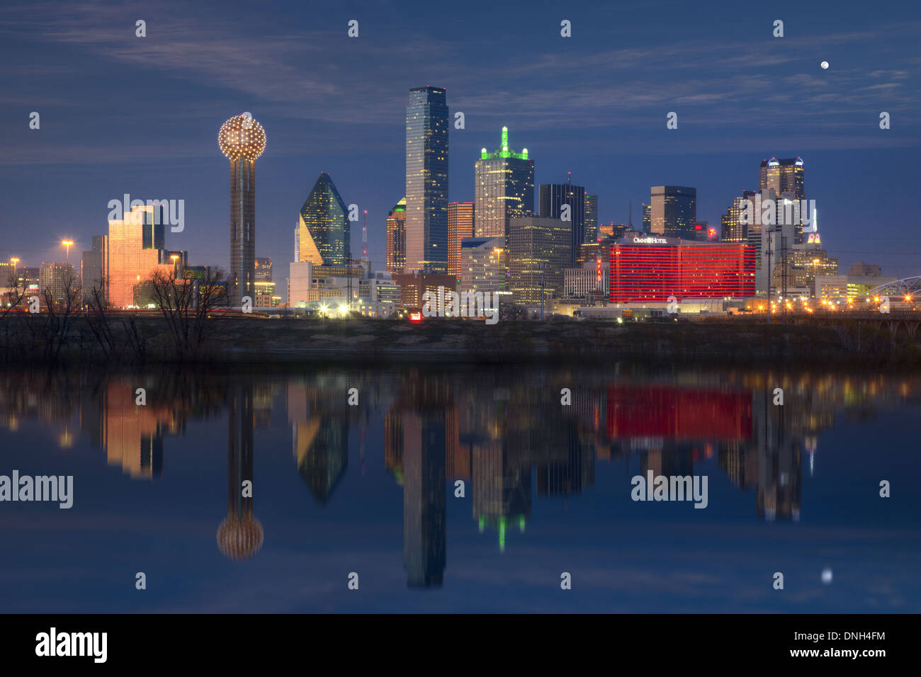 The Dallas skyline is reflected in an overflowing Trinity River in this