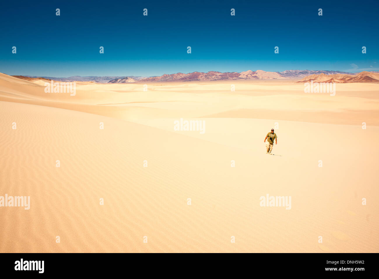 Man walking alone in the desert Stock Photo