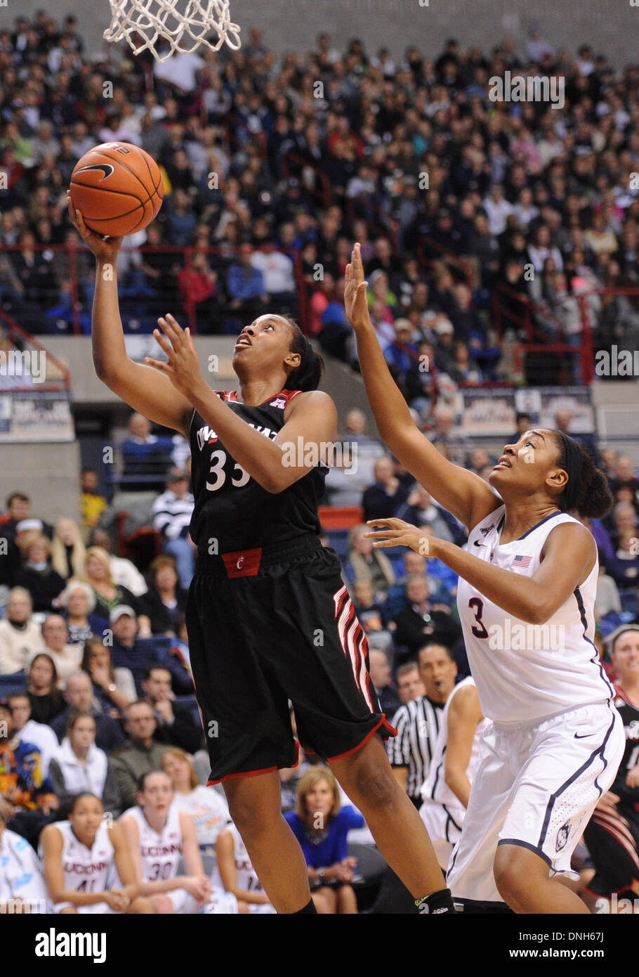 Storrs, CT, USA. 22nd Nov, 2013. Sunday December 29, 2013: Cincinnati Bearcats forward Jeanise Randolph (33) goes to the basket in front of UConn huskies guard-forward Morgan Tuck (3) during the 1st half of the womens NCAA basketball game between Cincinnati and Connecticut at Gampel Pavilion in Storrs, CT. Bill Shettle / Cal Sport Media. © csm/Alamy Live News Stock Photo