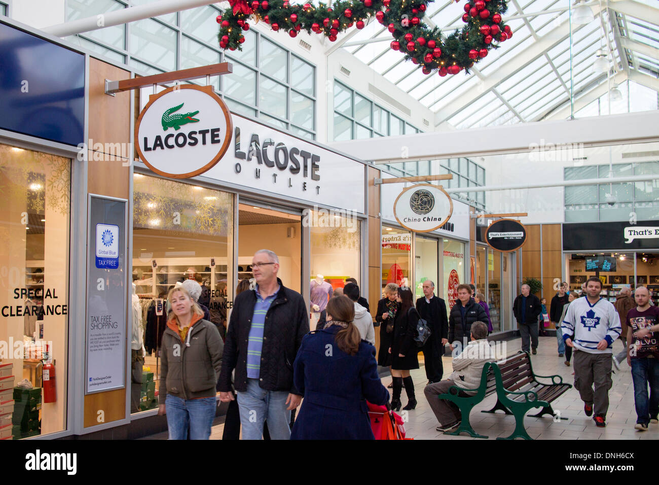 Shoppers at Lacoste outlet store at McArthur Glen York Designer outlet Stock Photo