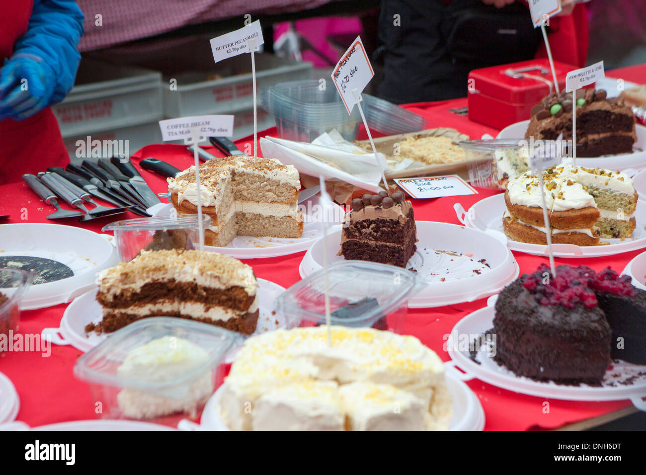 Outdoor market stall selling cream and chocolate cakes Stock Photo