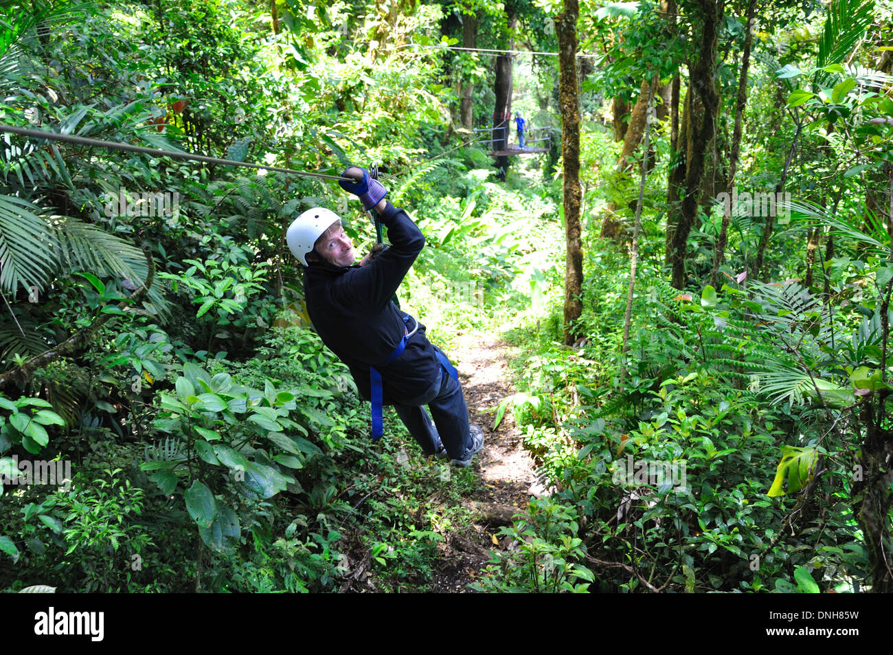 Man Zip lines in Monteverde cloud forest Costa Rica Stock Photo
