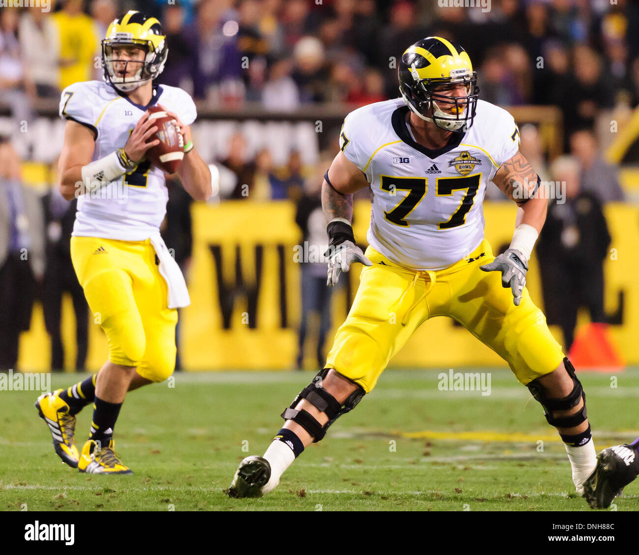 December 28, 2103: Michigan Wolverines offensive linesman Taylor Lewan (77)  in action during the Buffalo Wild Wings Bowl NCAA football game between the  Michigan Wolverines and the Kansas State Wildcats at Sun