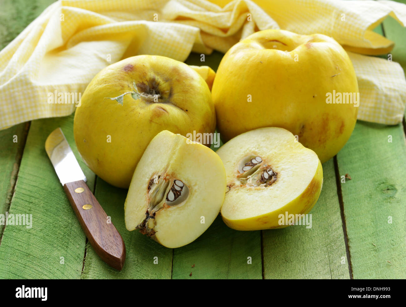 ripe yellow quince on a wooden table Stock Photo