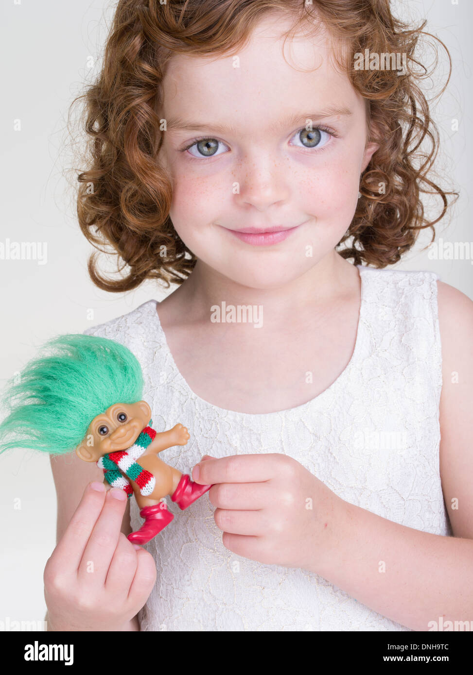 Young girl with Troll doll toy Stock Photo