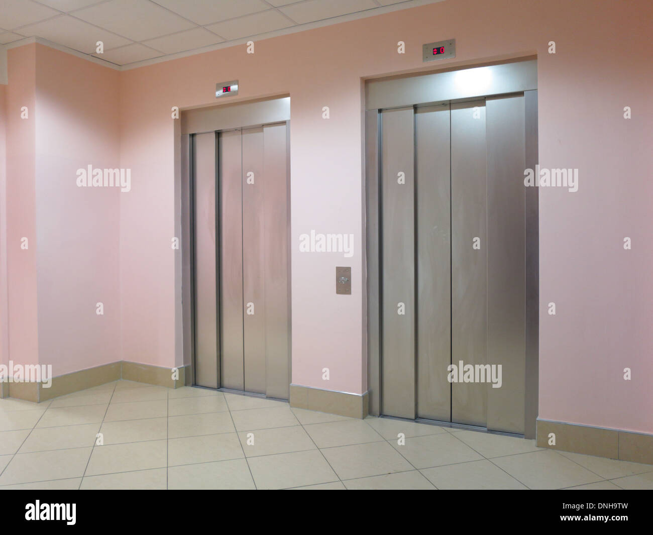 Two closed modern elevators in a business lobby Stock Photo Alamy