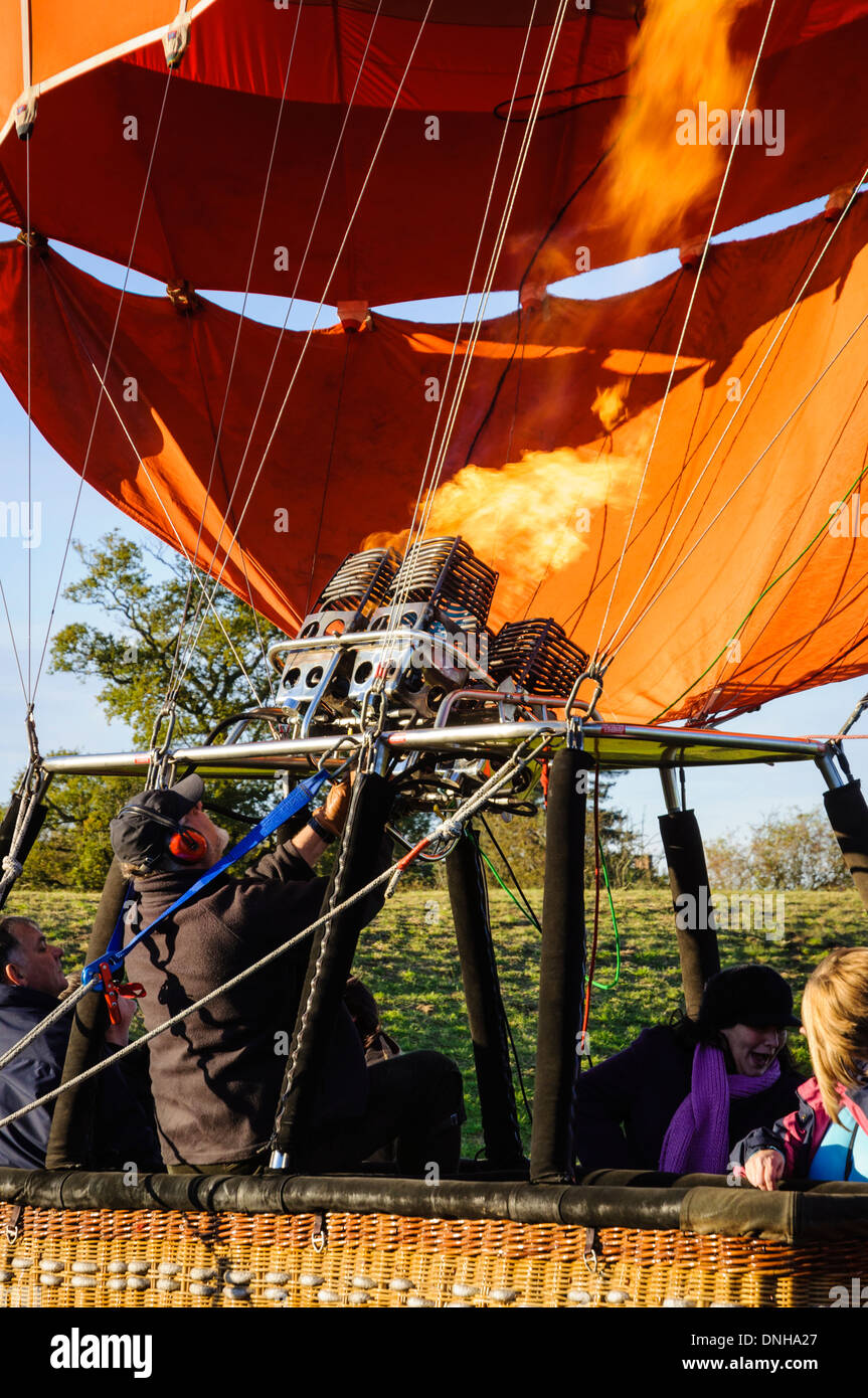 Hot air balloon pilot directs the burners in preparation for takeoff