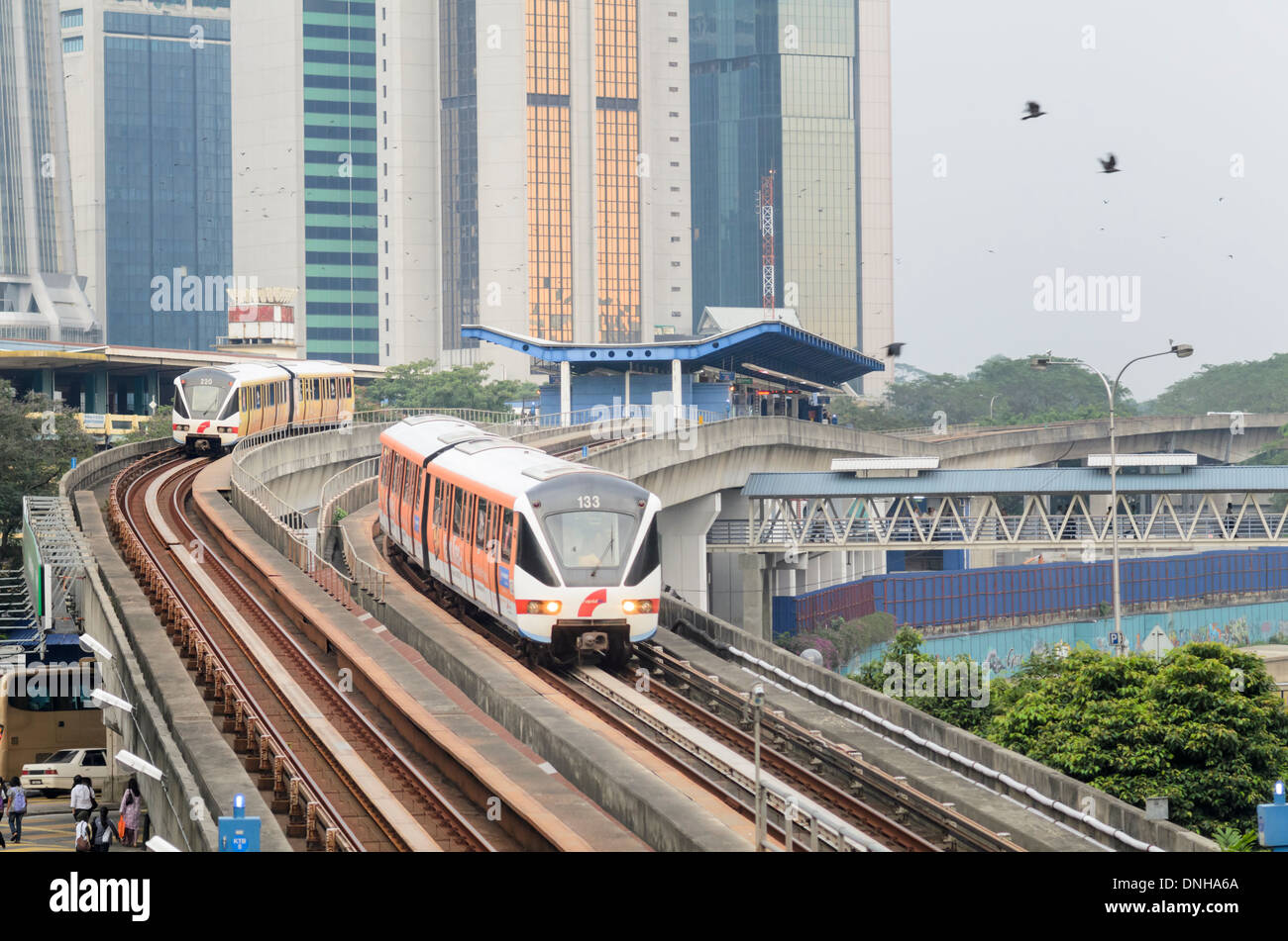 Modern Asian transport infrastructure: driverless commuter trains, elevated tracks and station Stock Photo