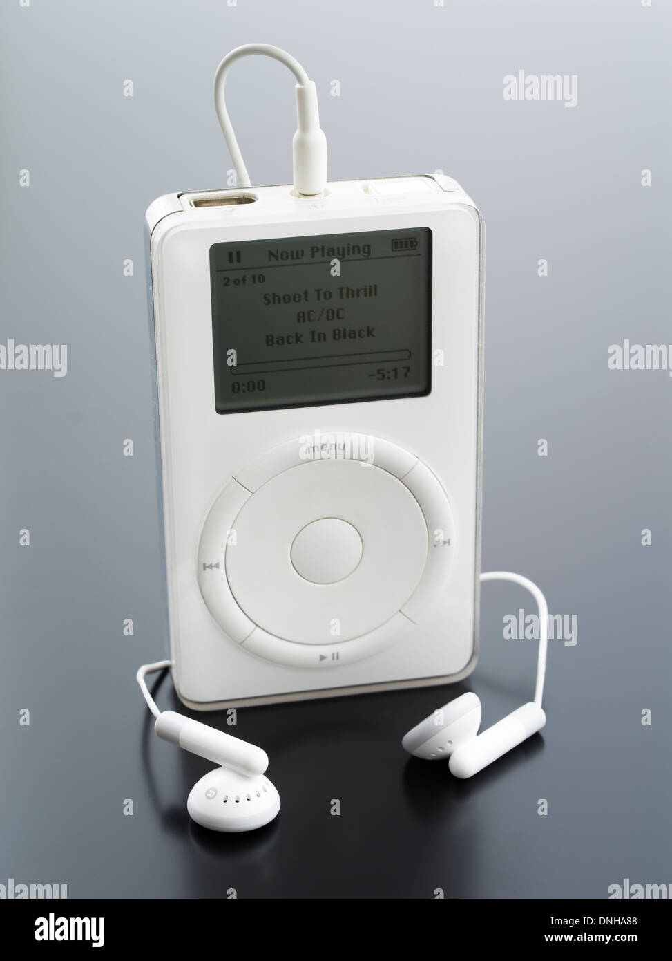Apple iPod 1st generation released October 23, 2001 with buds earphones in white   iconic portable music device Stock Photo