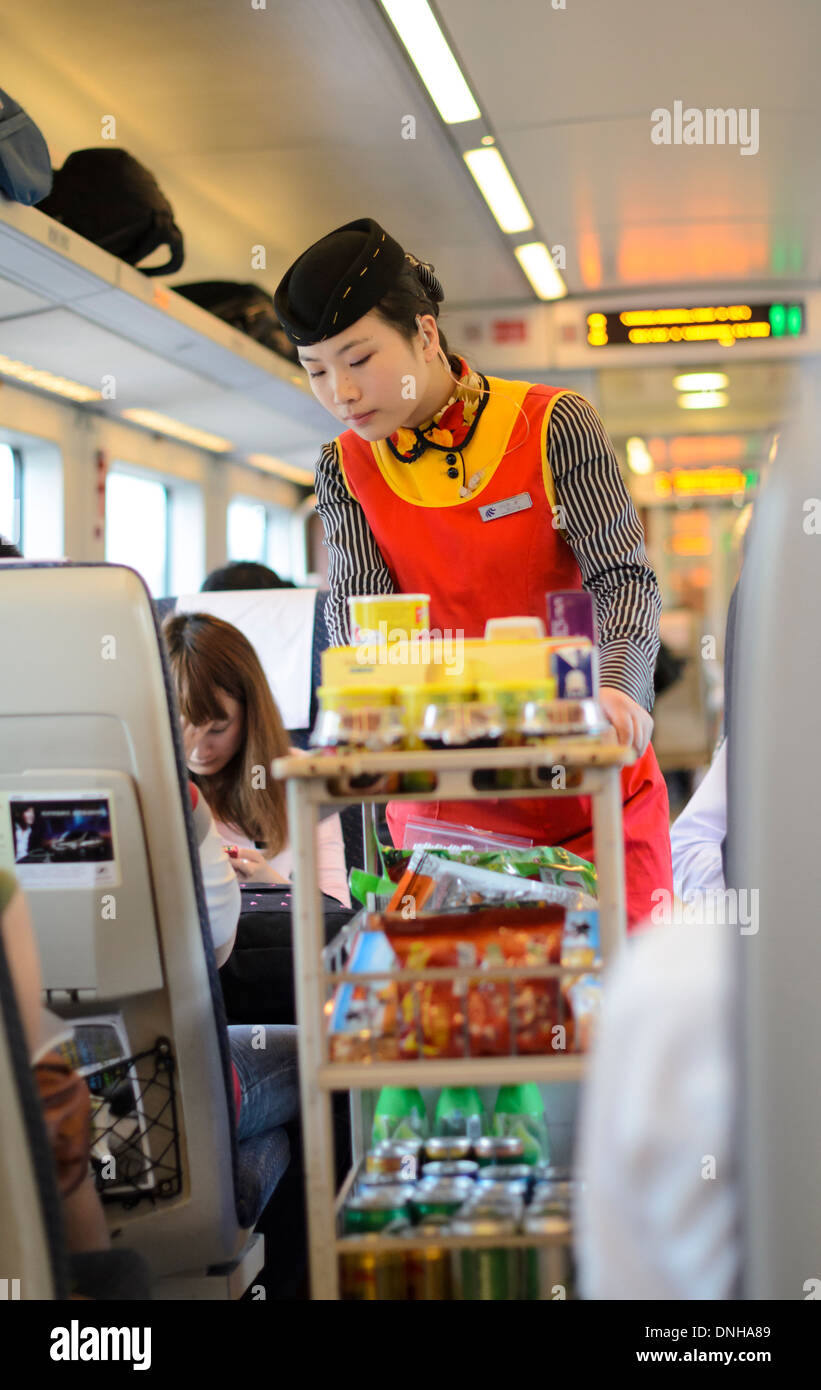 Drinks and snacks service trolley and server aboard a Chinese high speed train. Stock Photo