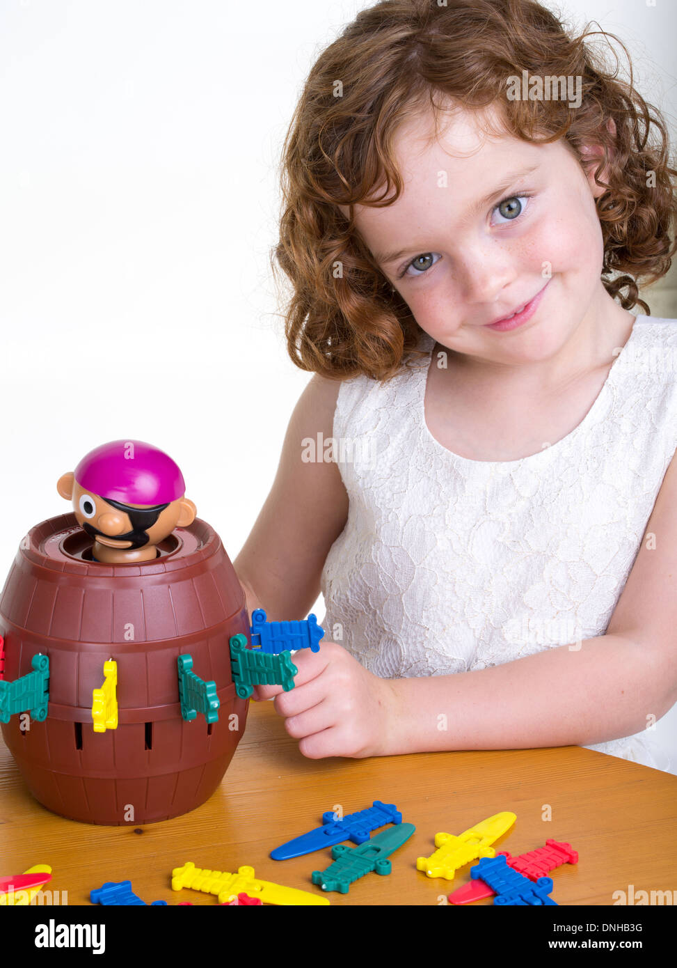 Young girl playing Pop-up Pirate game by Hasbro Stock Photo