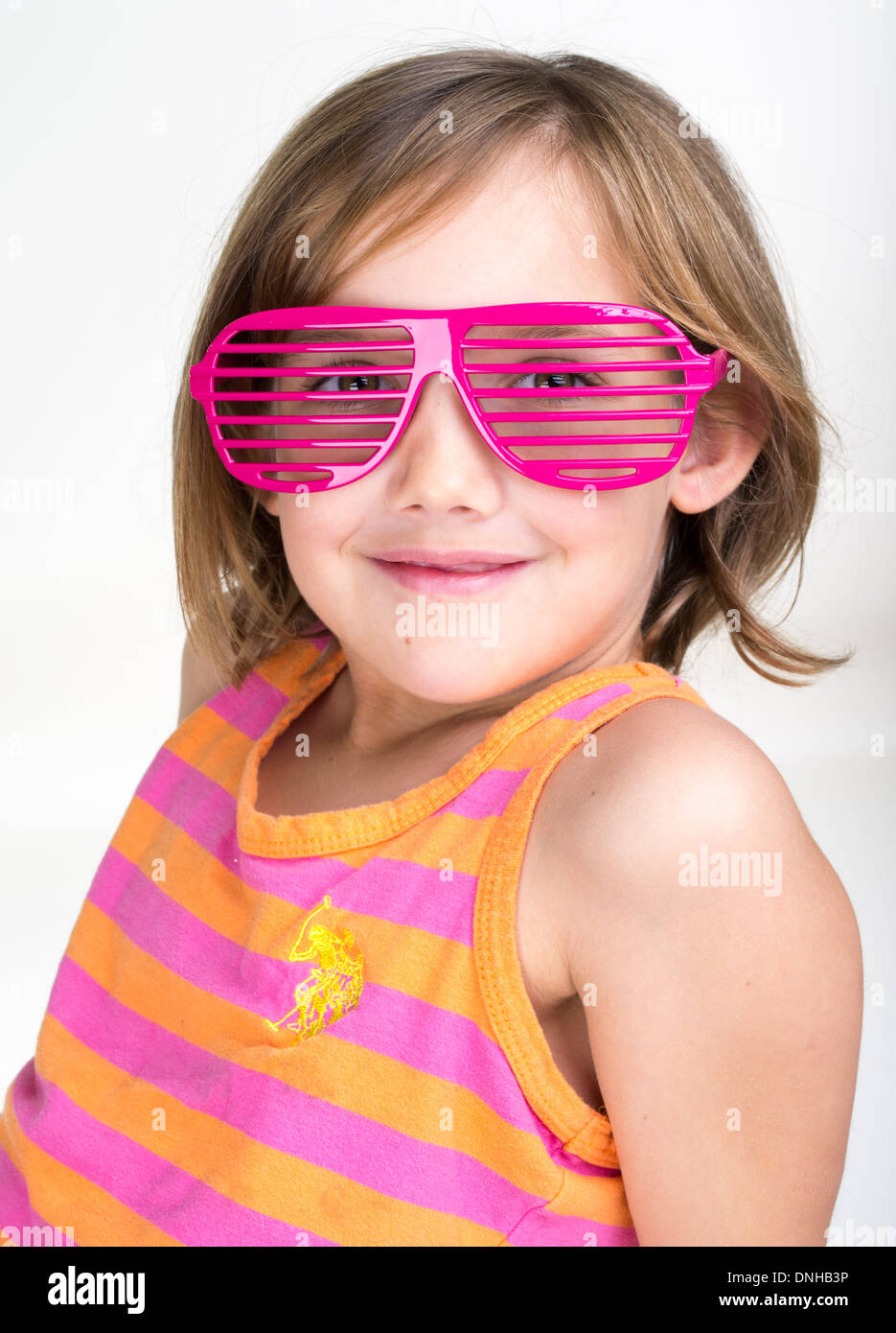 Young girl wearing pink shutter sunglasses Stock Photo
