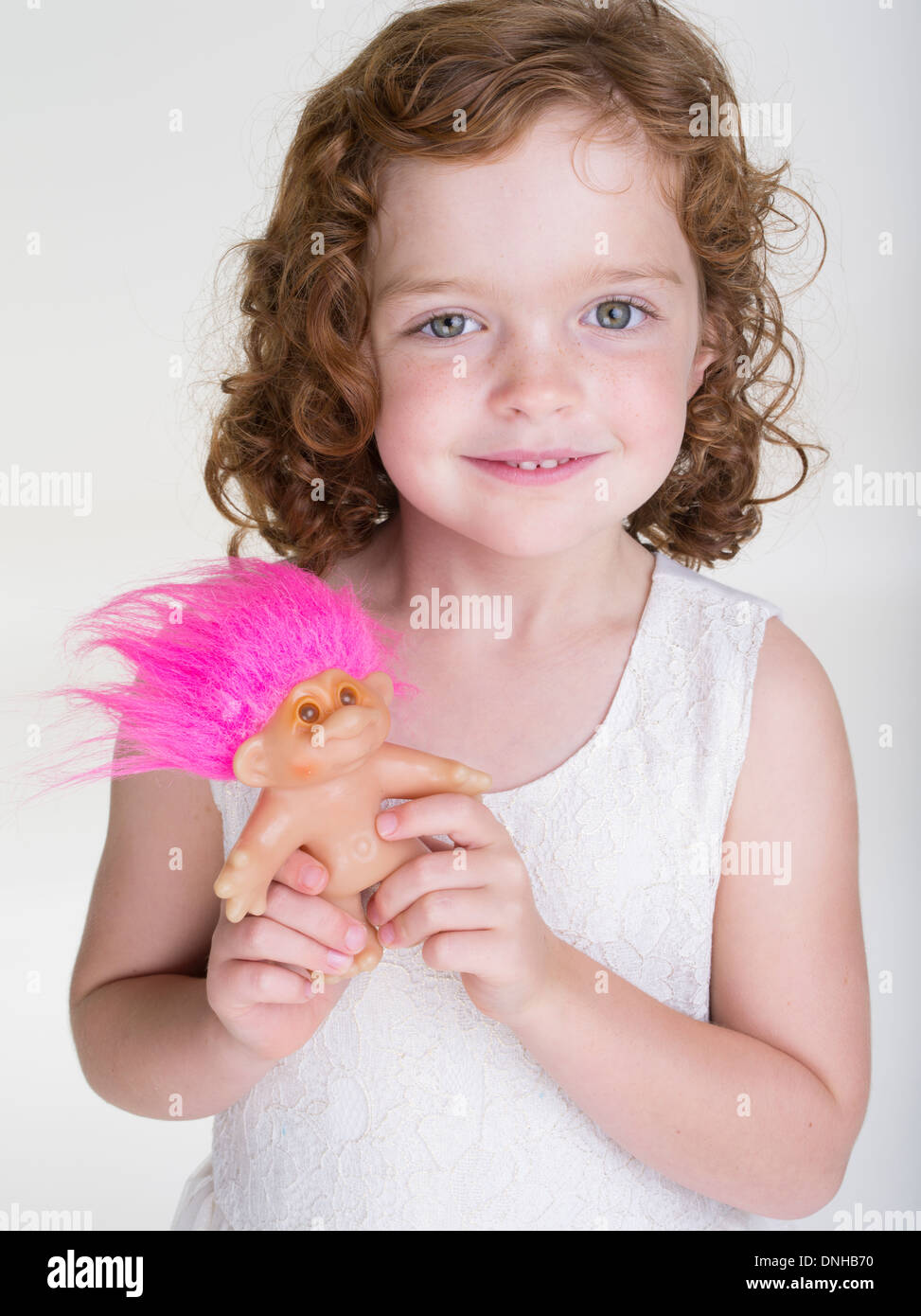 Young girl with Troll doll toy Stock Photo