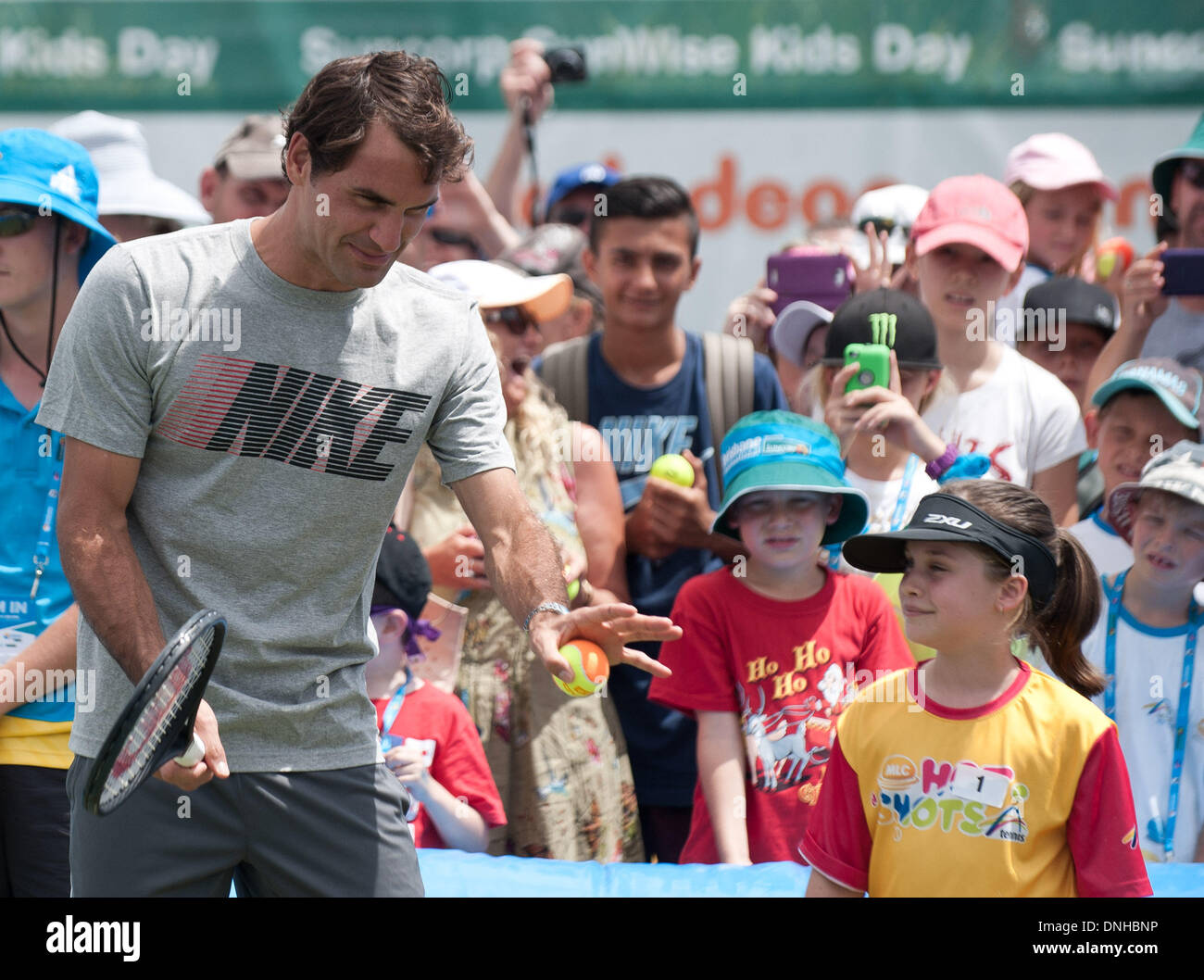 Brisbane, Australia. 30th Dec, 2013. Roger Federer of Switzerland plays with kids during 'Kids day' event at Brisbane International tennis tournament in Brisbane, Australia, Dec. 30, 2013. Credit:  Bai Xue/Xinhua/Alamy Live News Stock Photo