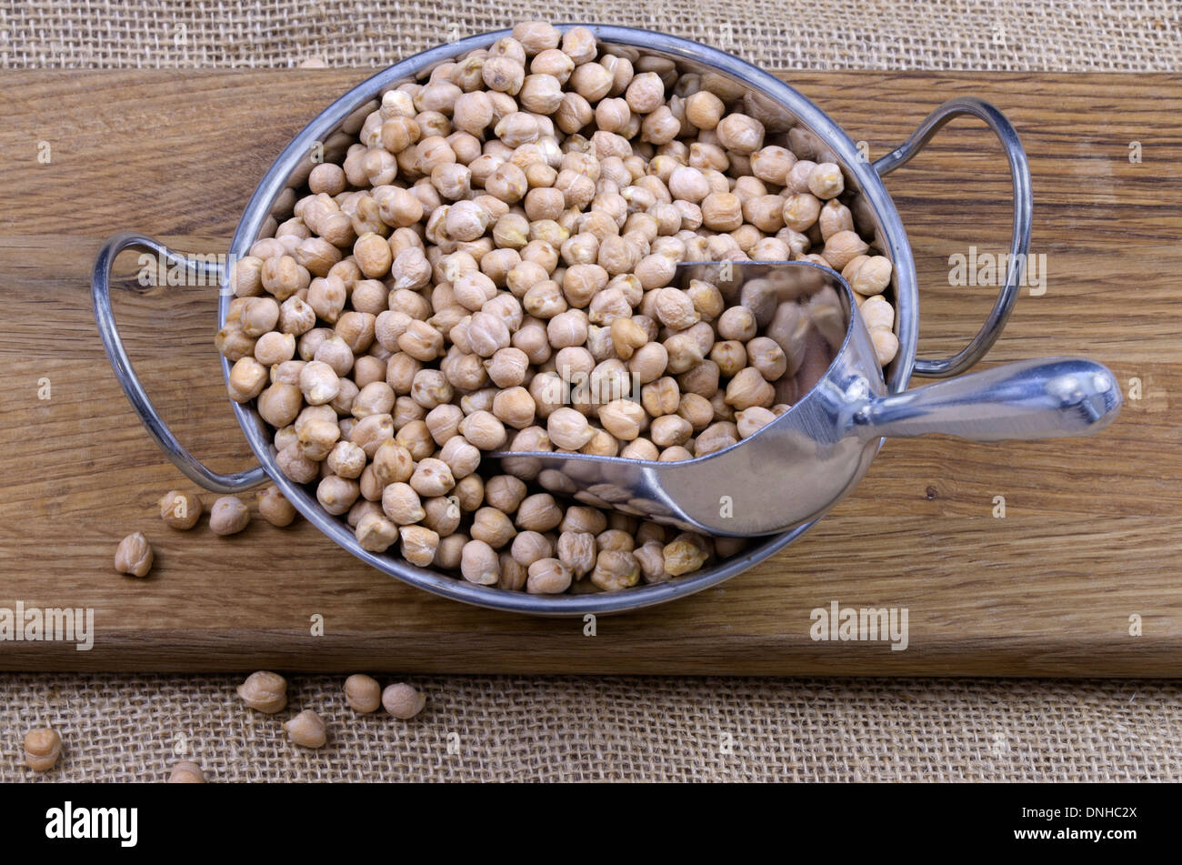 Bowl of dried chickpeas on a wooden board Stock Photo