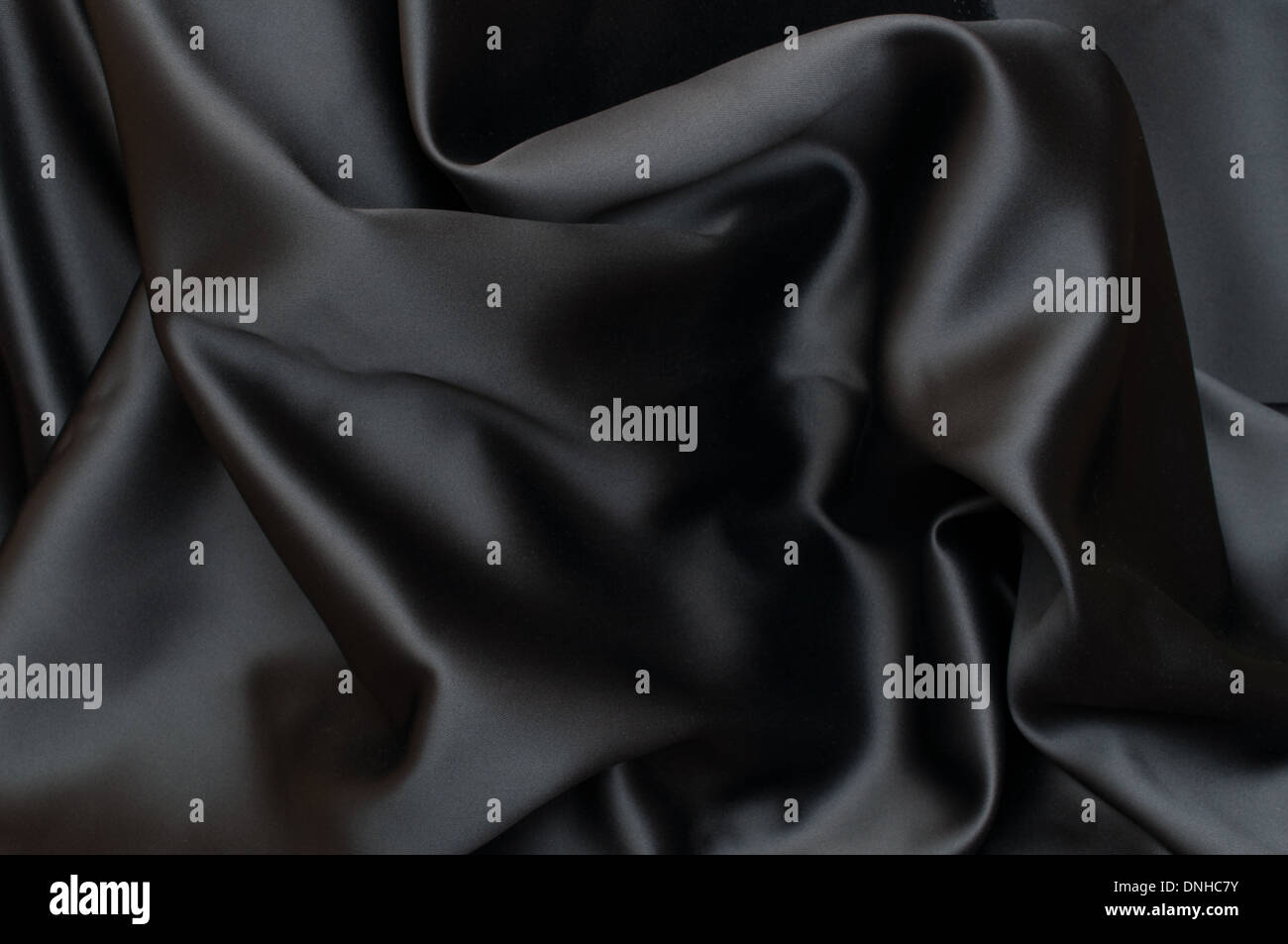 Black Texture - Dark Wavy Glossy Silk Drapery - Shallow Depth of Field Stock Photo
