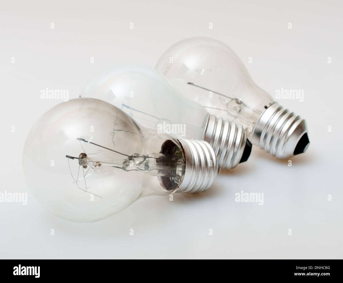 Three Aged Burnt Bulbs on Light Background - Shallow Depth of Field Stock Photo