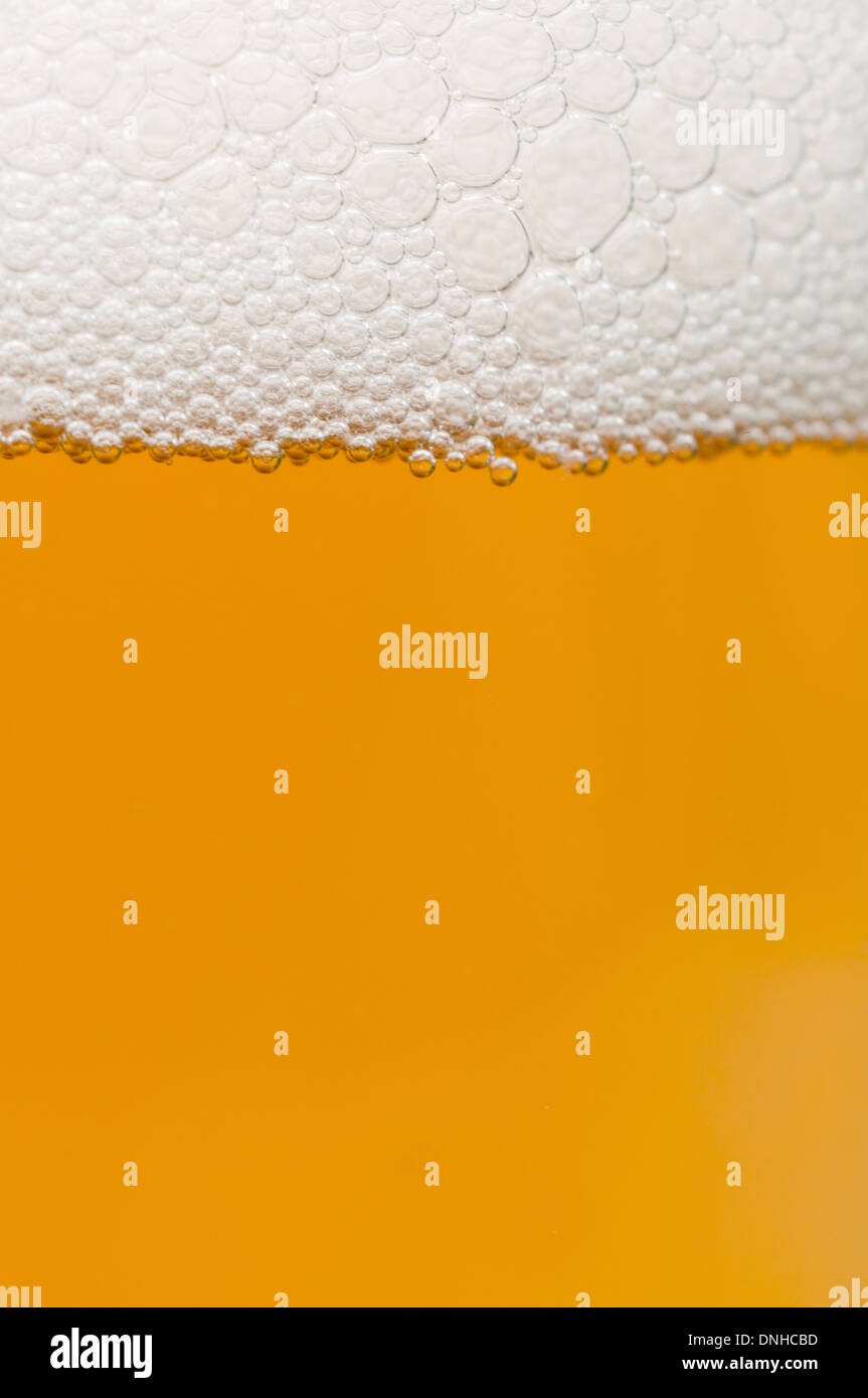Beer - Closeup of Glass of Beer with Foam - Shallow Depth of Field Stock Photo