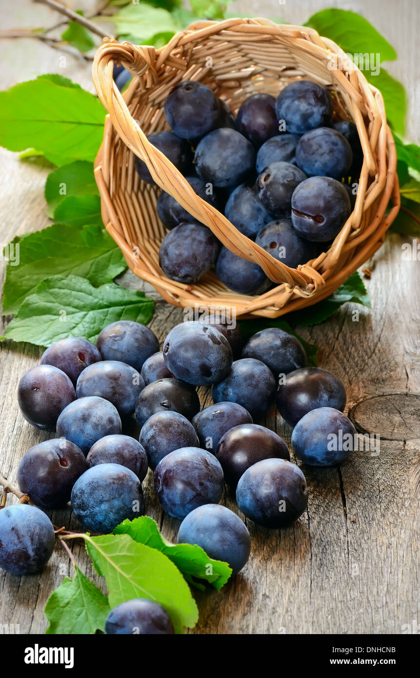 Ripe plums on the wooden table Stock Photo
