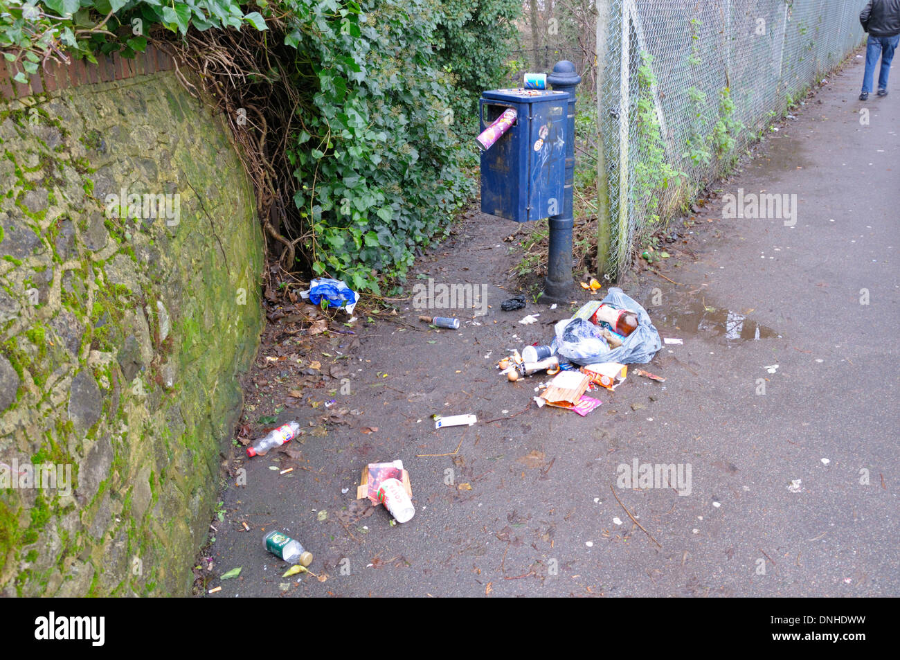 Maidstone, Kent, England, UK. Overflowing rubbish bin on a footpath