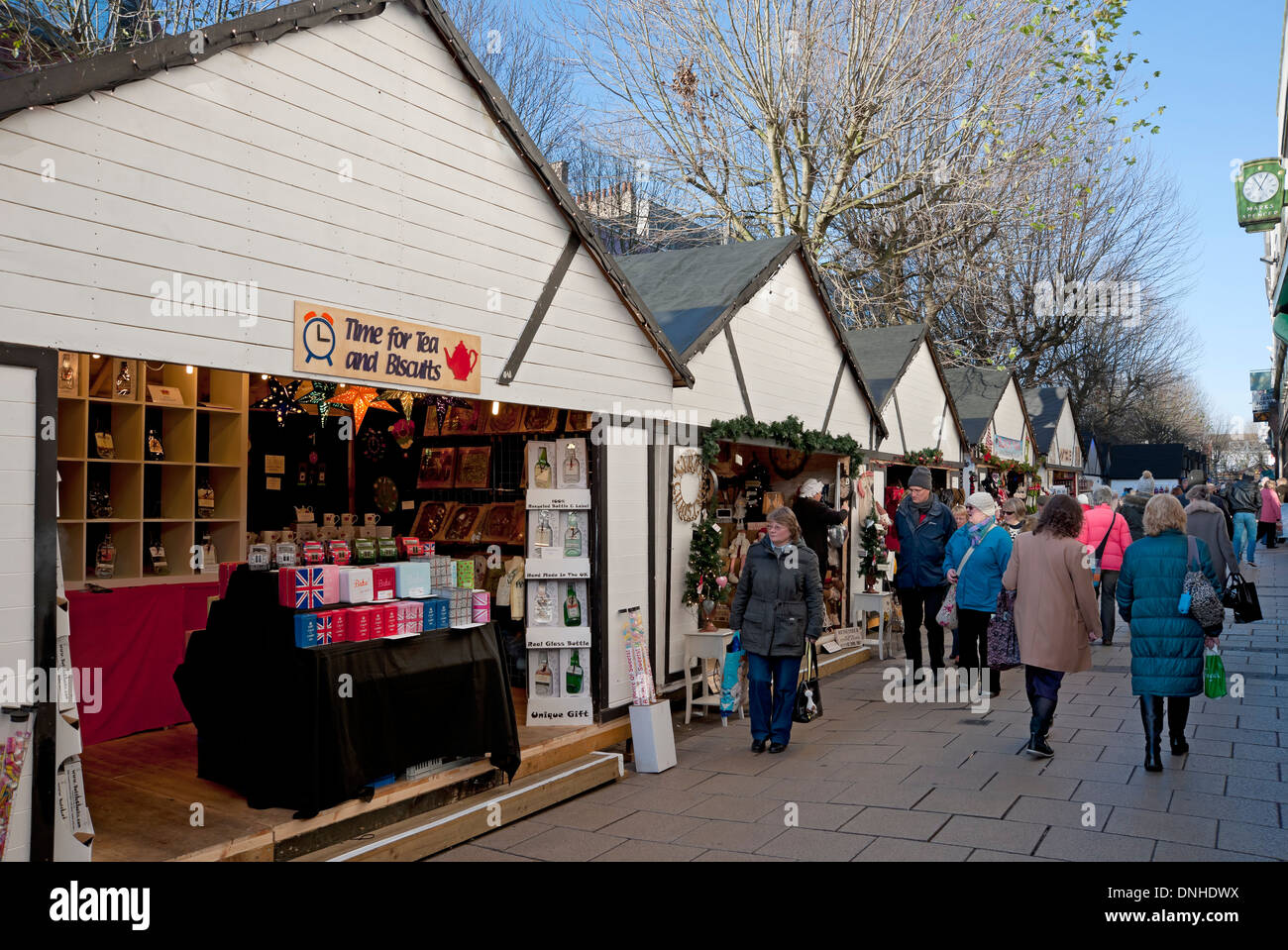 People Visitors shoppers shopping visiting Christmas market stalls York