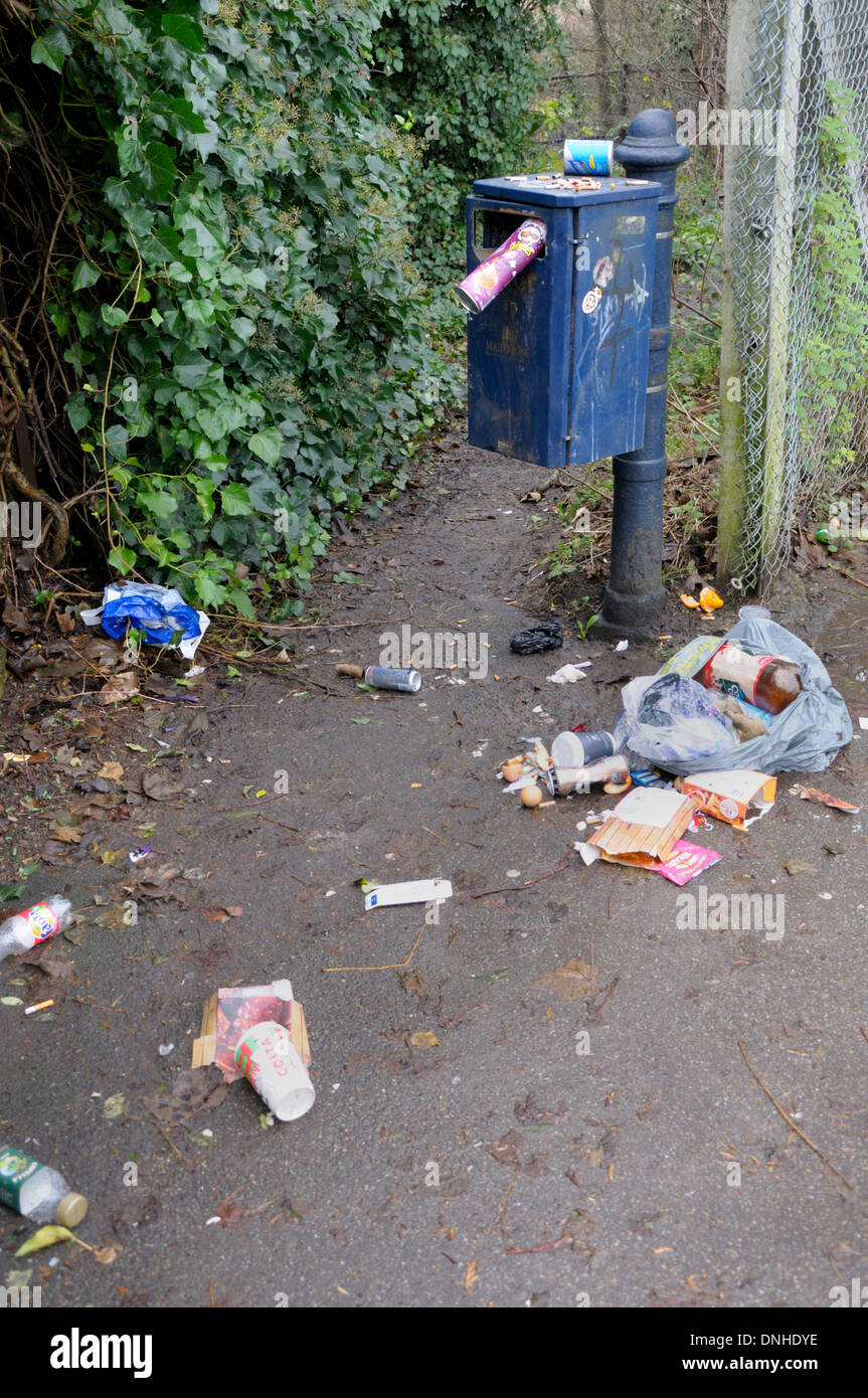Maidstone, Kent, England, UK. Overflowing rubbish bin on a footpath