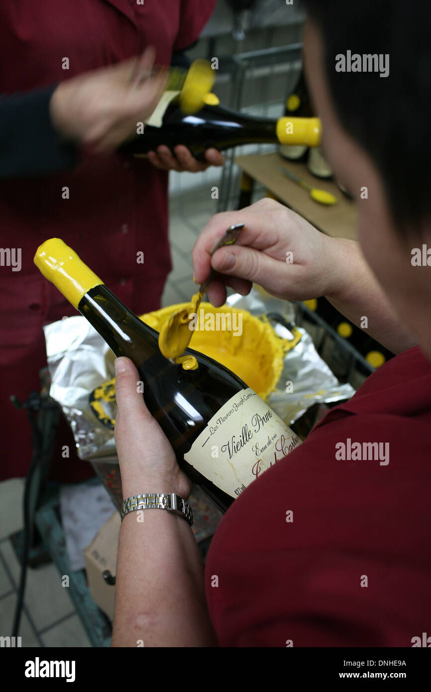 Wine bottles hand-sealed with wax, premium bottles. Bottle sealing wax  protecting corks from excess moisture Stock Photo - Alamy